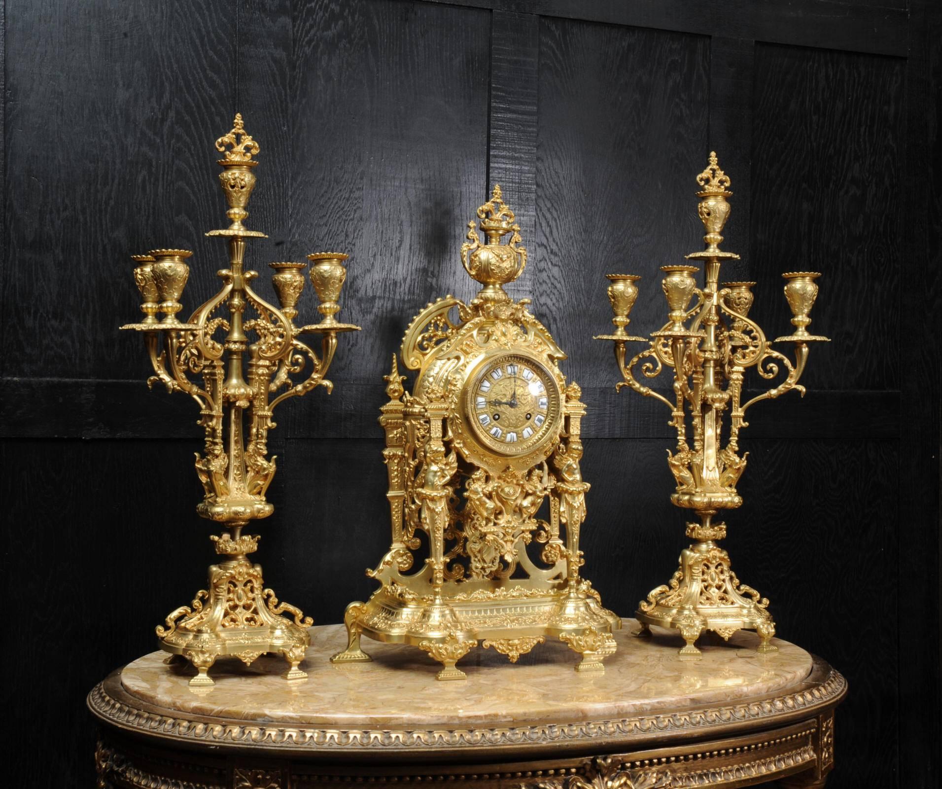 A very finely detailed gilt bronze clock set in excellent original condition, retailed by the Paris retailer Pierre Lemasson and dating from circa 1870. The style is Baroque. The clock movement is held aloft by cherubim forming the front pillars.