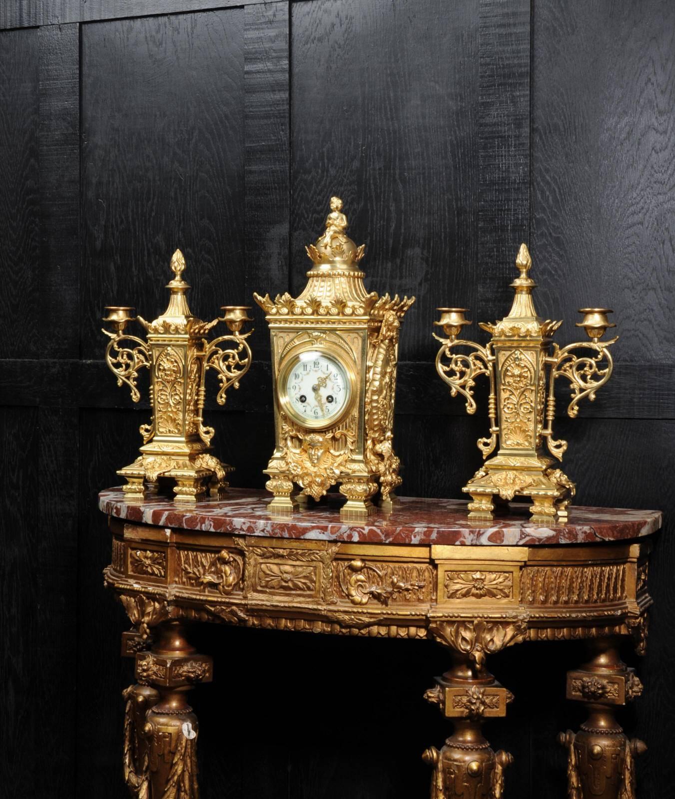 A beautiful, classically designed antique French gilt bronze clock set by Japy Frères dating from, circa 1900. It features oval panels to the sides showing Fortuna, the goddess of luck, an emperor to the front and lions masks. To the top of the