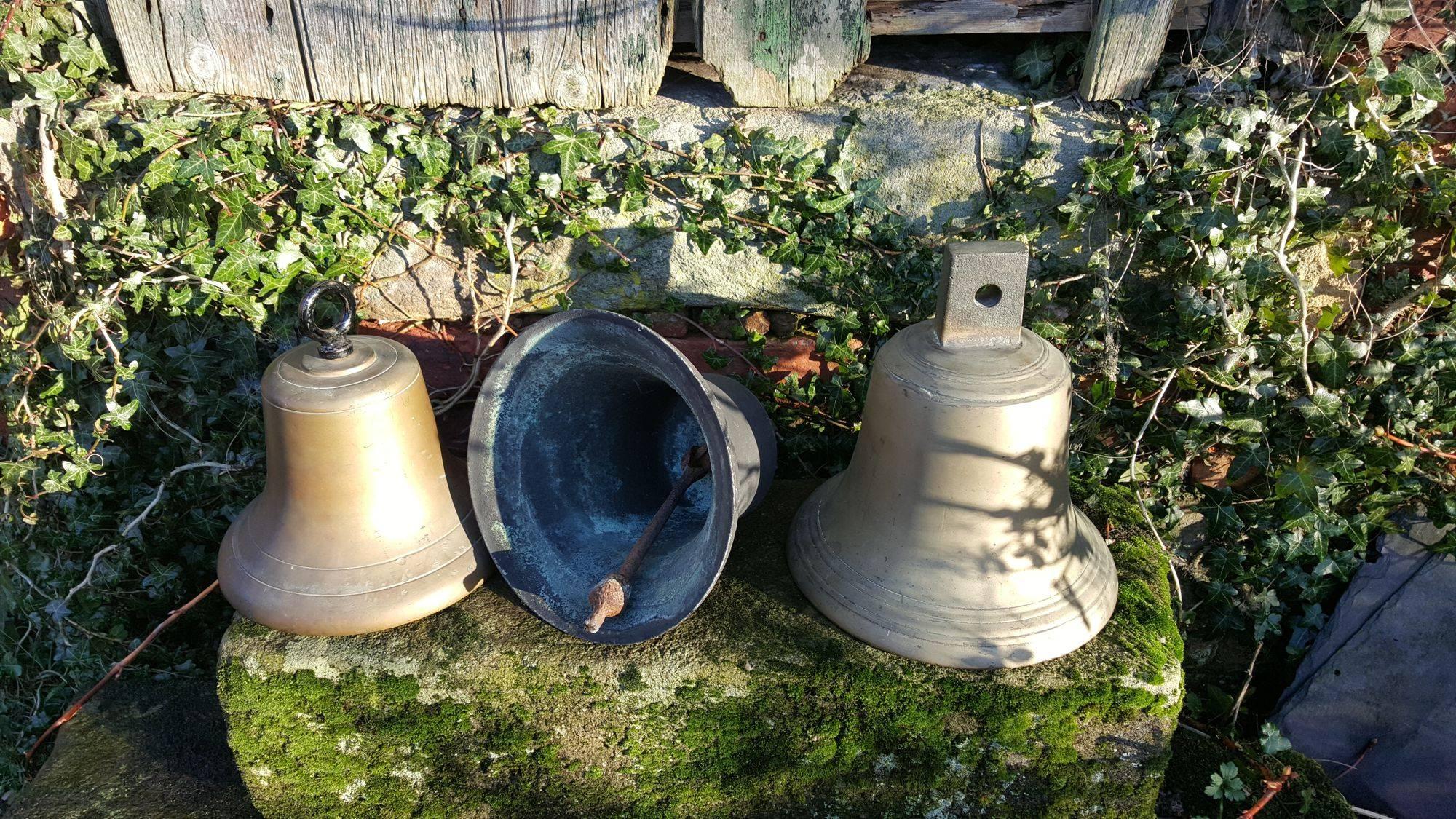 Three vintage or antique bronze bells with lovely weathered patina.