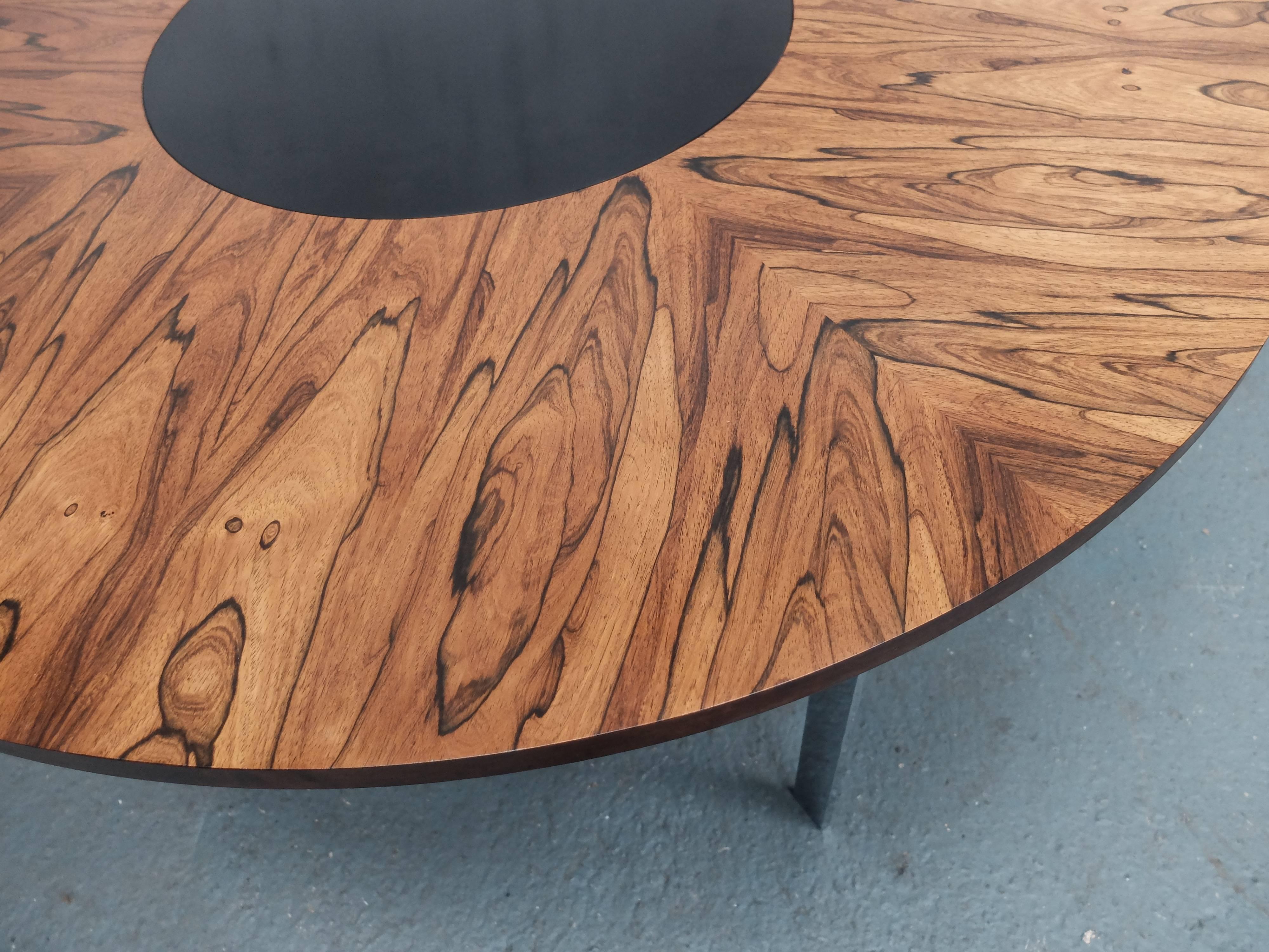 Midcentury rosewood dining table by Merrow Associates, circa 1960s
On chrome legs with a revolving, 'Lazy Susan'
Designed by Richard Young, London, 1960s.
Strong rosewood grain pattern with contrasting black revolving mid-section.