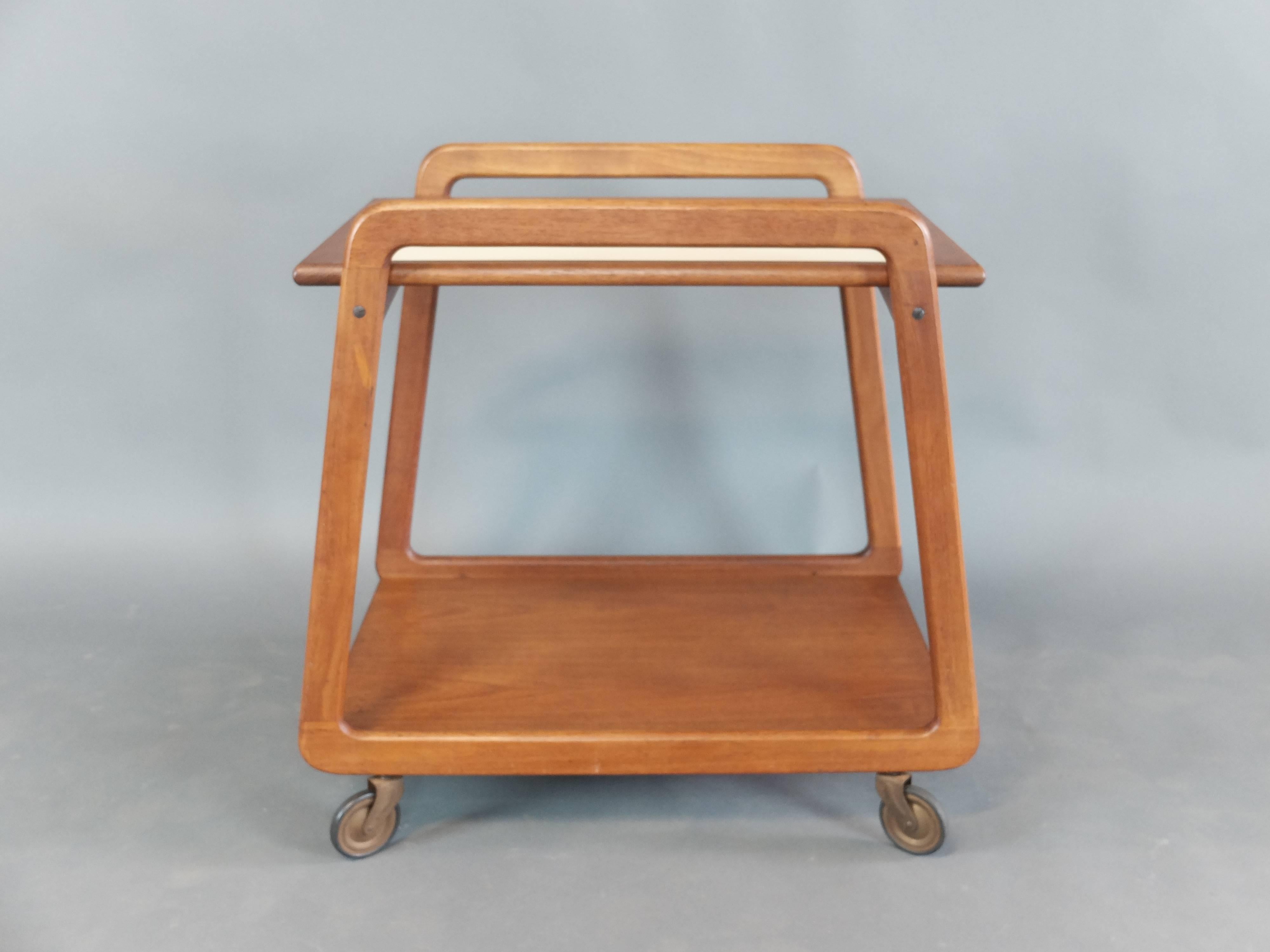 Mid-Century Danish teak drinks trolley by Sika Mobler
Two-tier trolley with reversible lift off top shelf or tray.
Finished in teak and white laminate.
With maker's stamp.