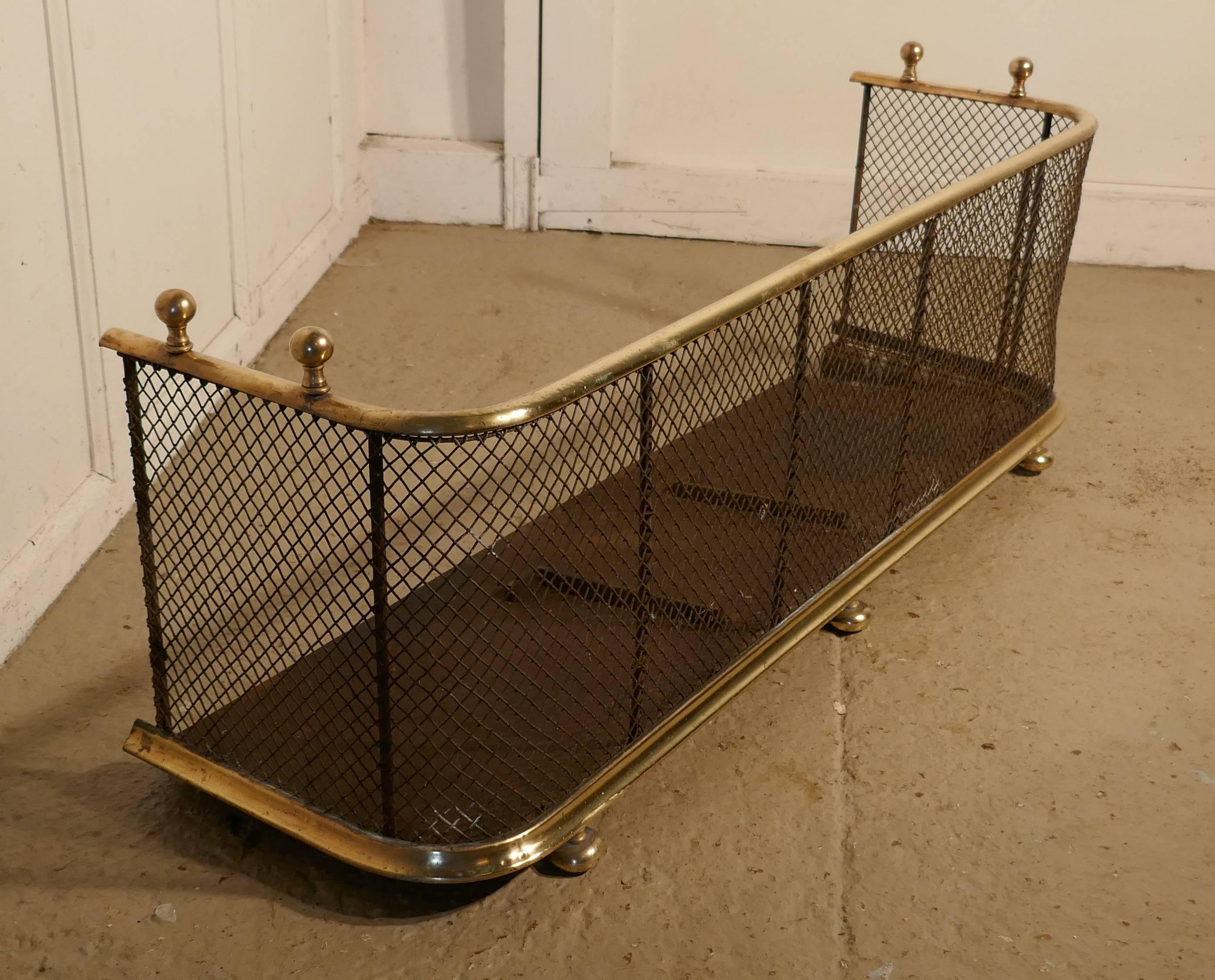 A Victorian brass and iron fender or fireguard
 
A Victorian antique fire guard often known as a club fender, the iron guard has wire mesh and brass rails top and bottom, it has brass knobs on the top and it stands on brass feet, the fender is in