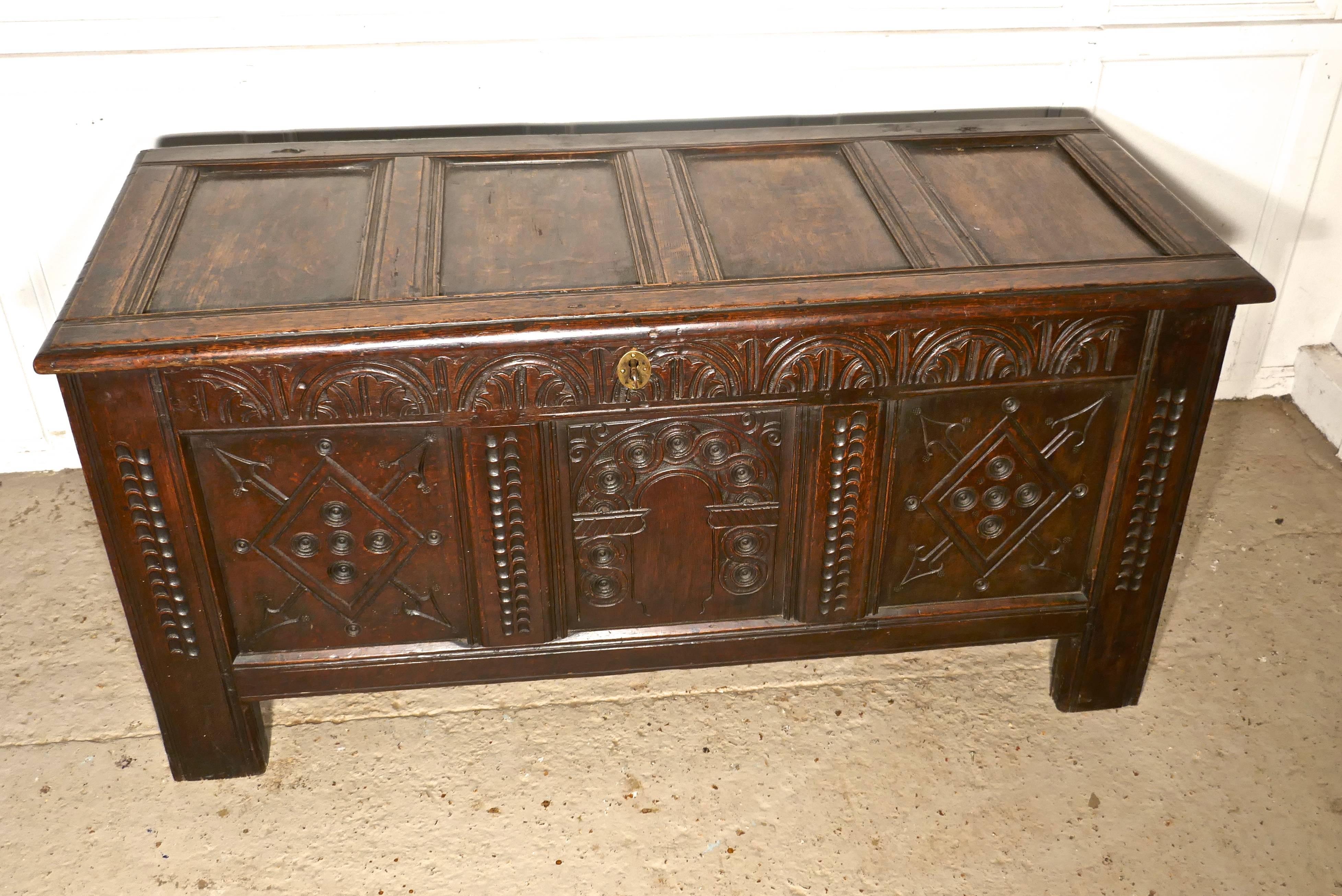 17th century carved oak coffer

This is a lovely old piece, with a superb patina, the chest has three beautifully carved panels and frieze on the front at the top. It has a key, working lock and a brass escutcheon, these are not original but they