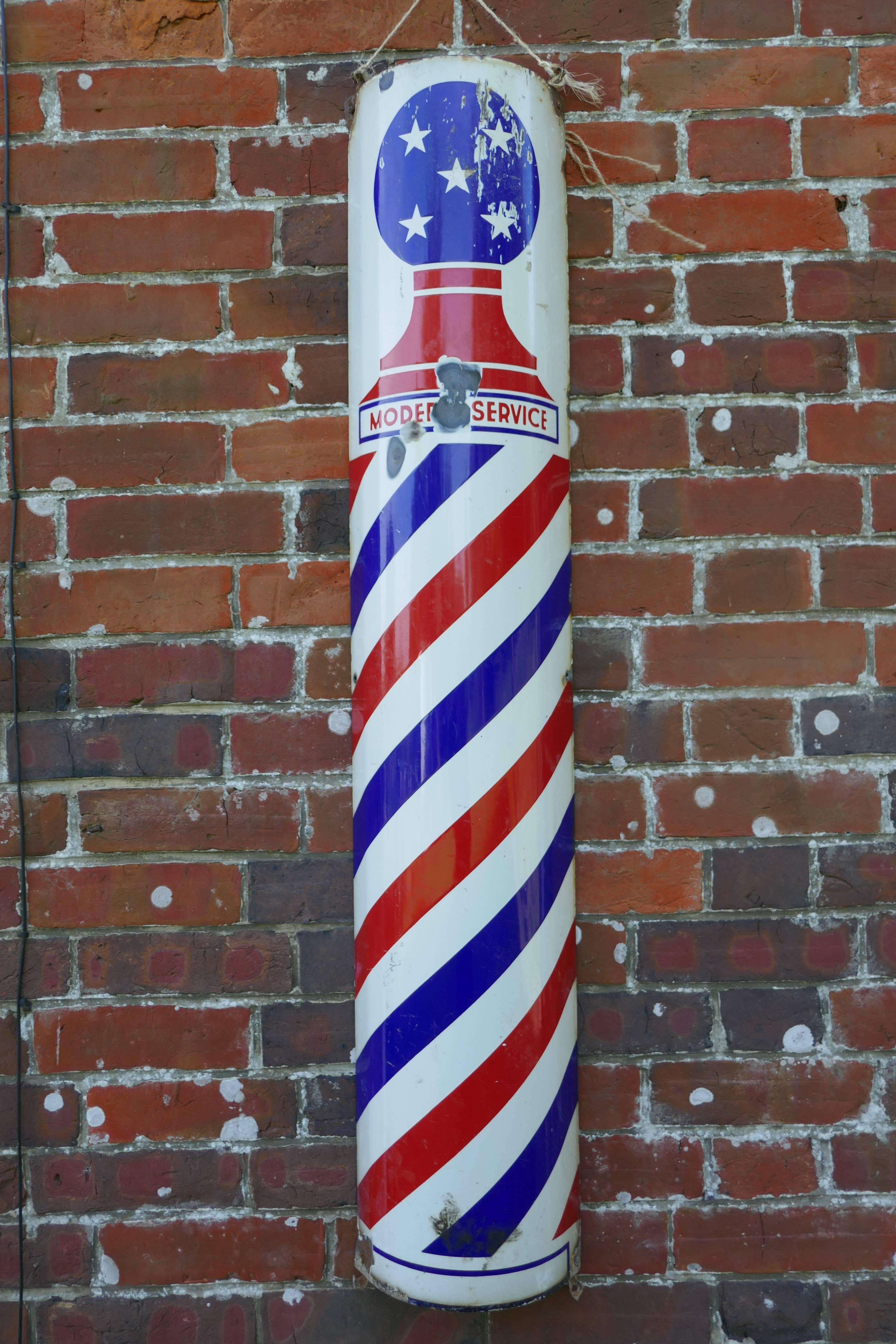 Rare porcelain enamel barbers pole shop sign.

This is a very rare old sign, it is American in origin, we have the red and blue stripes wrapped around a White background, and at the top white stars on a Blue background, the motif at the top says