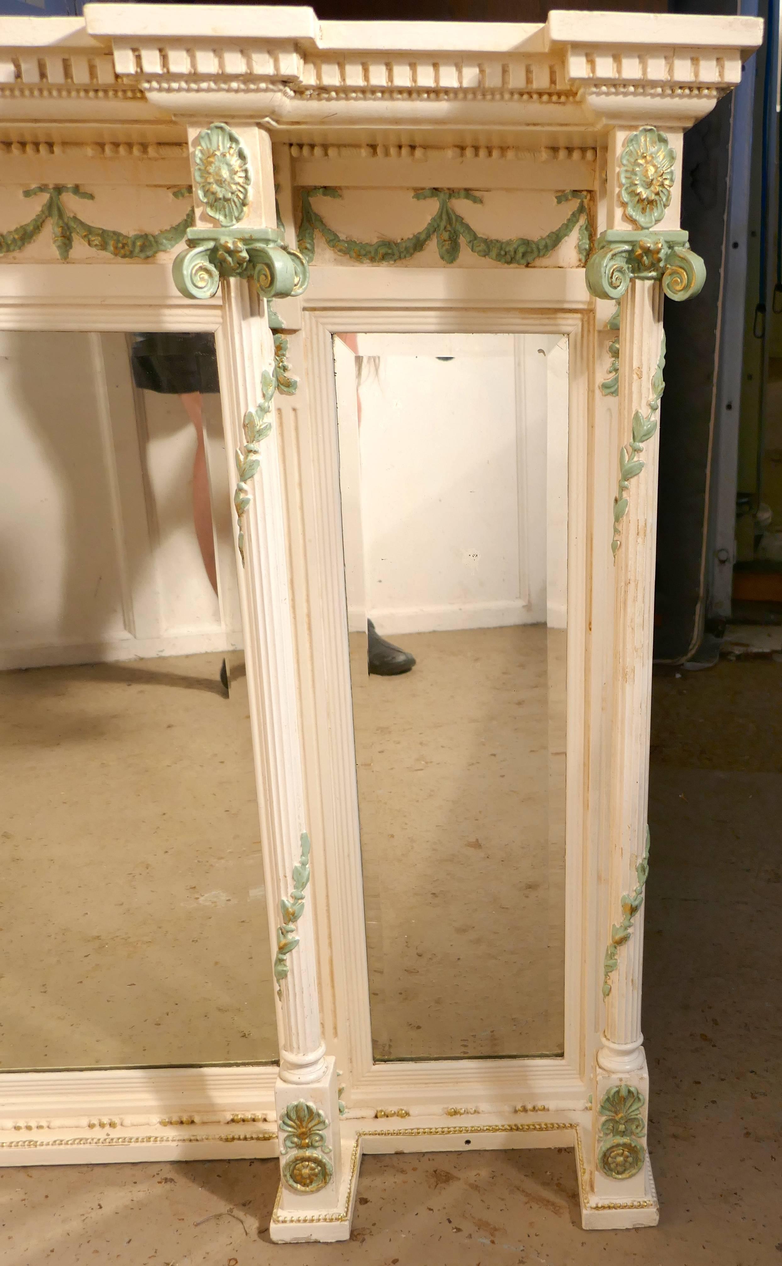 19th century painted over-mantel

A charming 19th century painted Regency style over-mantel
The carved Frame has three beveled glass mirrors, each bordered with Corinthian style columns and a break front dental cornice around the top The mirror