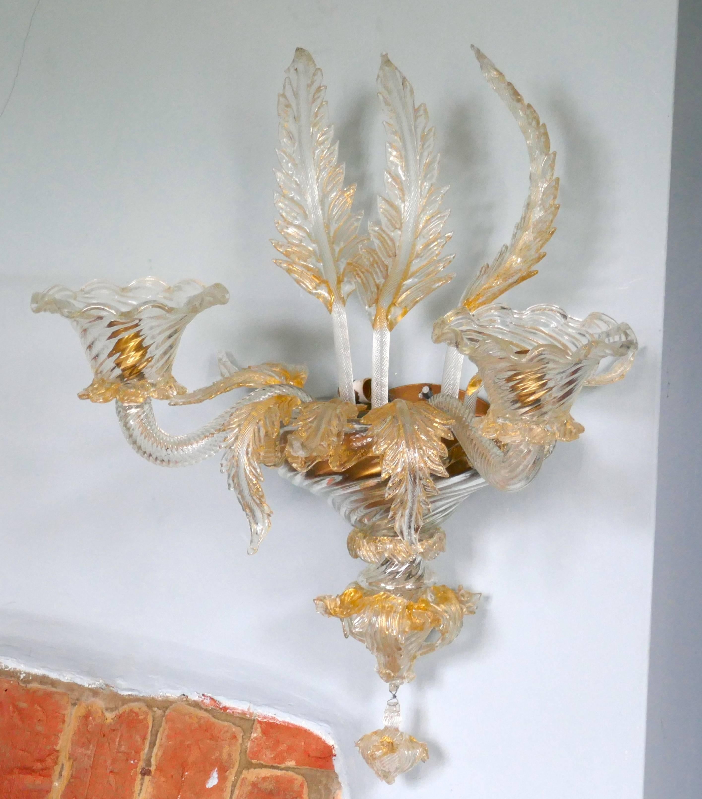 Pair of Superb Venetian Glass and Gilt Chandelier Wall Lights

A truly rare and outstanding pair of wall lights, the lights are hand made in Venetian glass and highlighted with gold
The lights are large and are each lit by three-light bulbs, one
