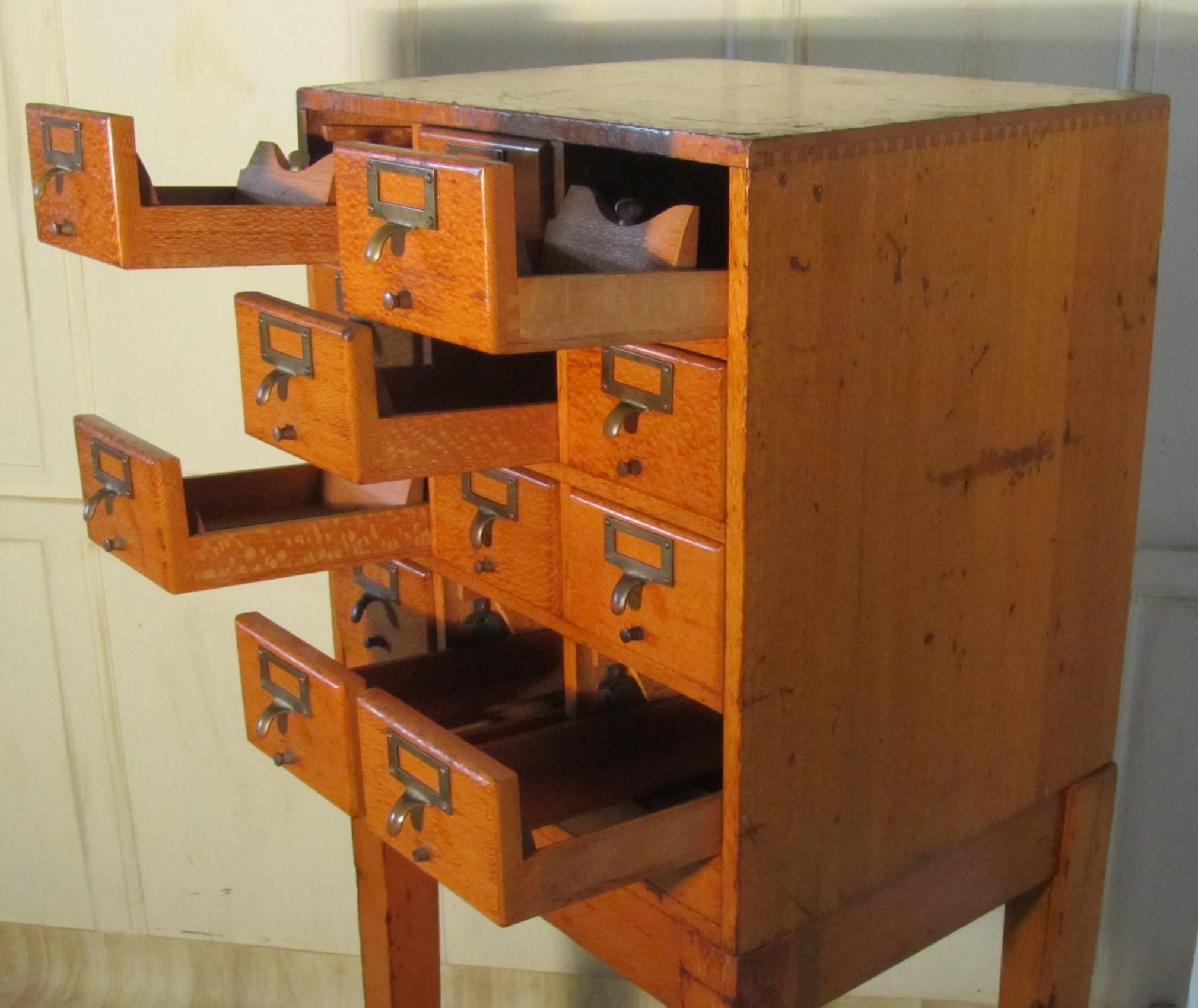 12-drawer golden oak card index filing cabinet, wine rack
 
The cabinet has four rows of three drawers, each with a brass handle / name plate holder, and comes with its original stand

The cabinet is in sound original condition all the drawers