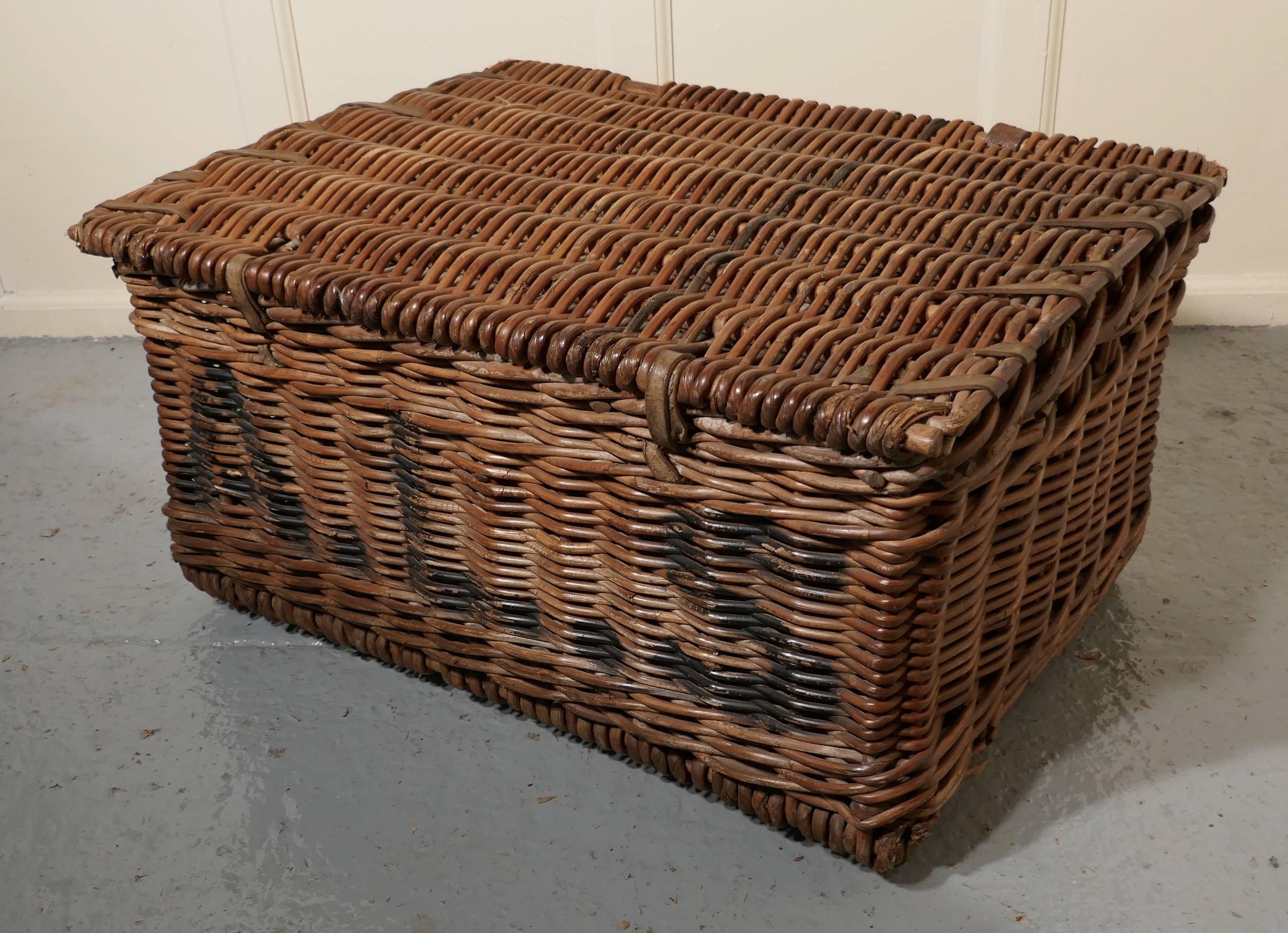 A large Victorian wicker linen basket or hamper

An attractive age darkened wicker linen basket or Hamper and it has a flat lid to the top, there are two leather fasteners on the front and the basket has a wooden frame at the bottom so it is very