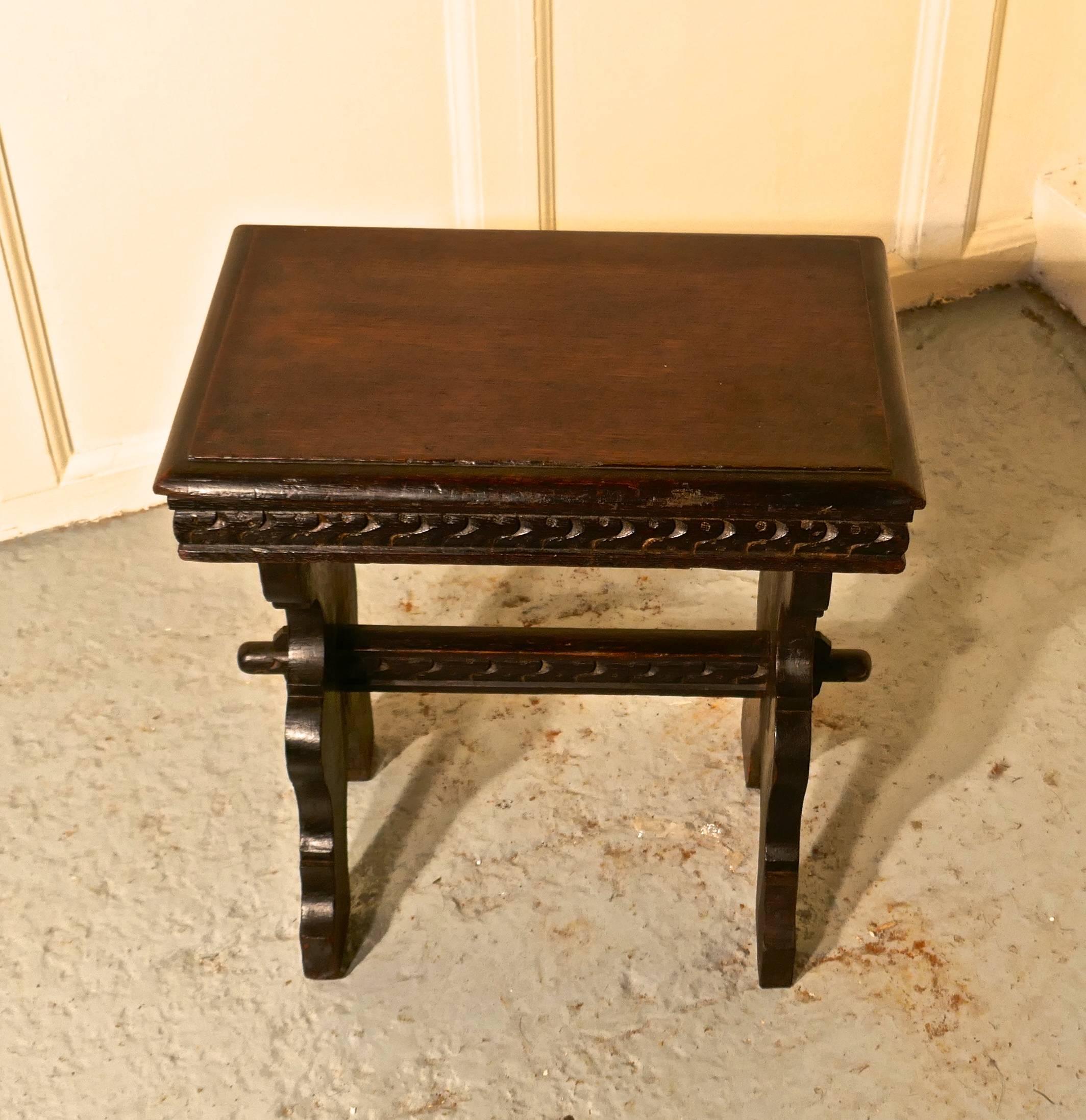 Victorian Gothic oak farmhouse kitchen stool

A lovely country piece with a superb natural colour and a gorgeous patina, it has a thick seat which is carved around the edges it is made in the Refectory style with pegged carved cross stretcher and