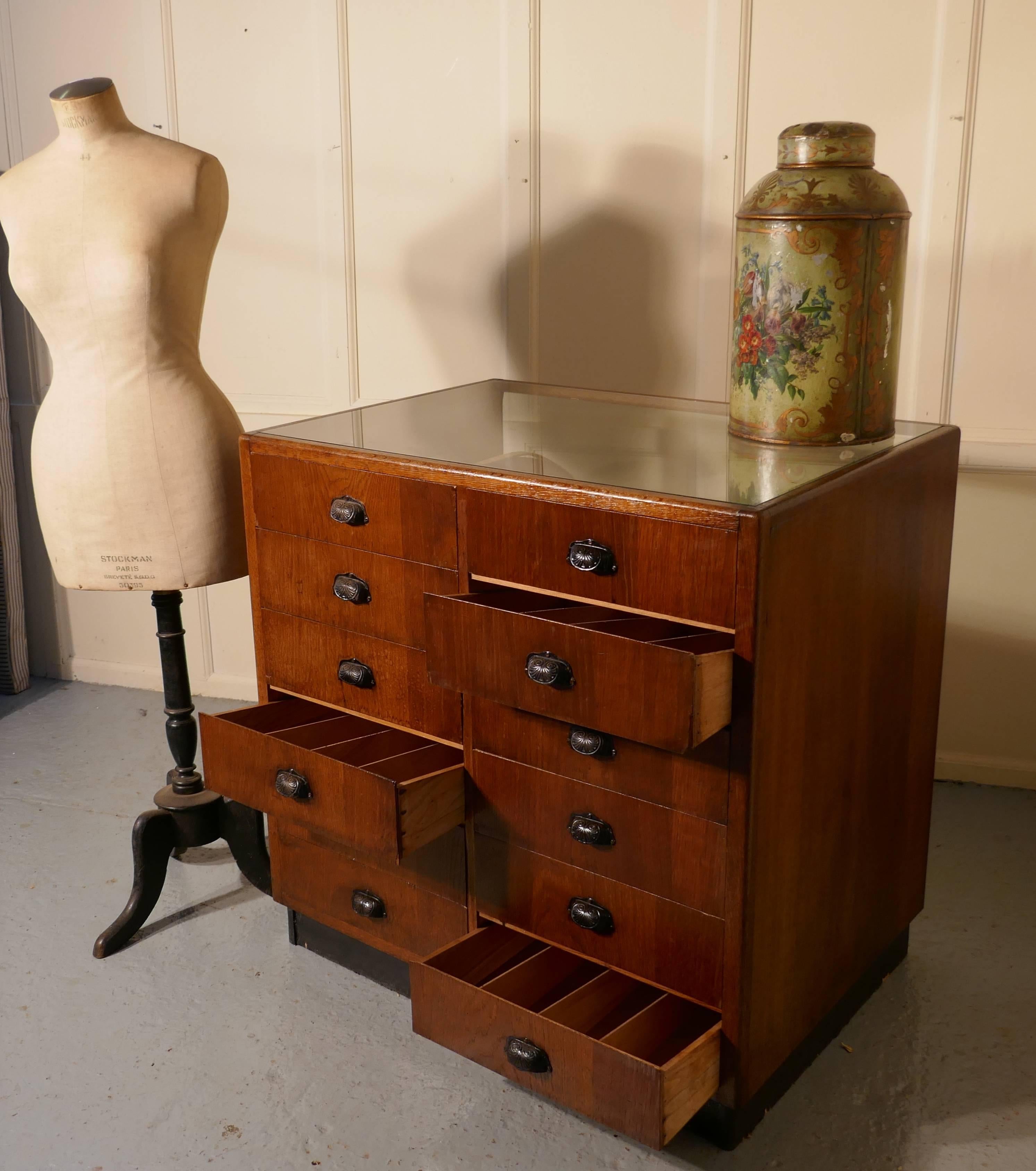 Vintage Art Deco Haberdashery shop fitting

The haberdashery shop counter is a lovely small size and has two banks each of six graduated drawers, there are removable dividers in the drawers, the cabinet is made in light oak, with a curved Odeon