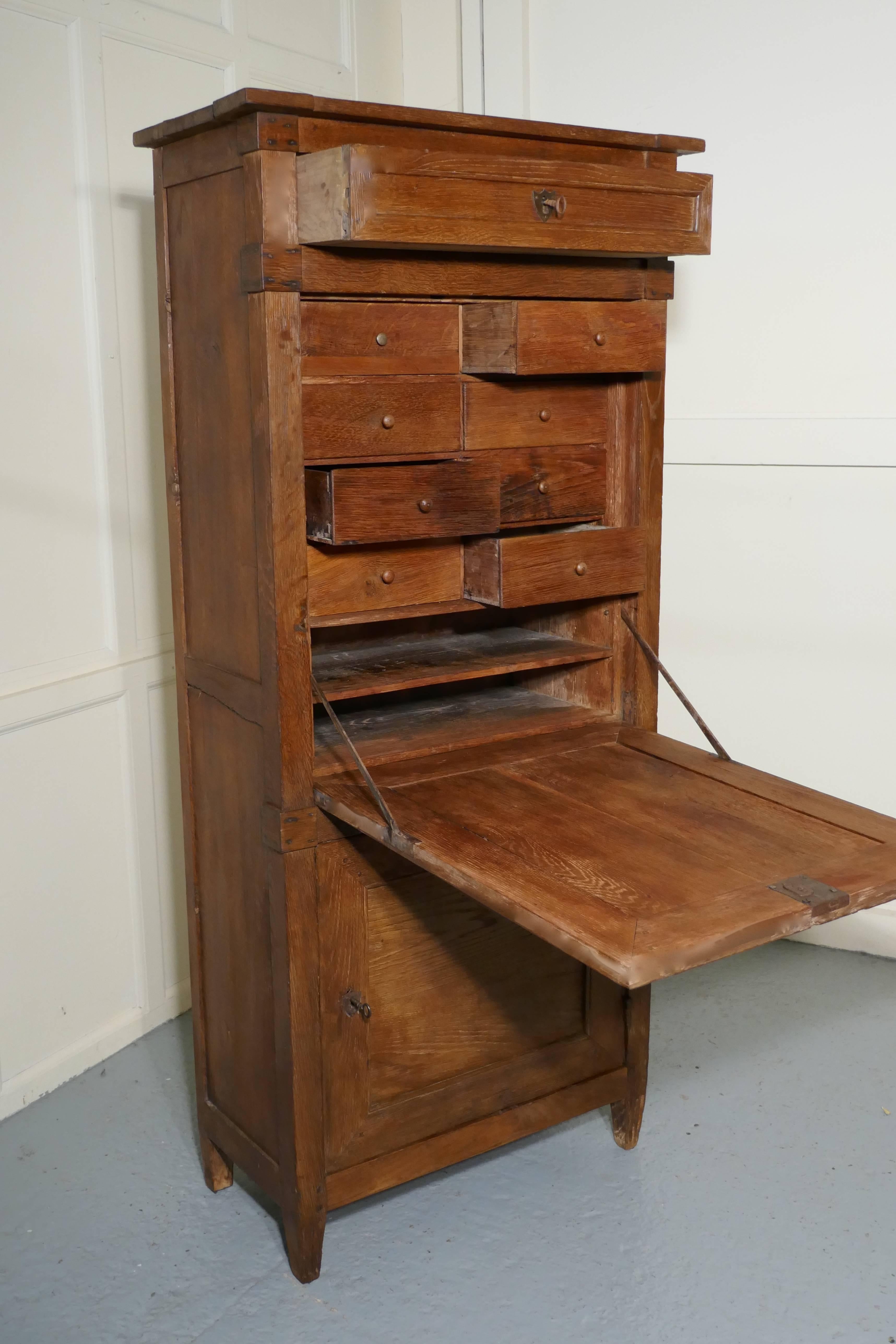 17th century French country oak secrétaire à abattant

This is a lovely and very old piece, the cabinet is tall and narrow, it has a drawer at the top and a fall in the centre with a single shelved cupboard beneath. The interior of the bureau has