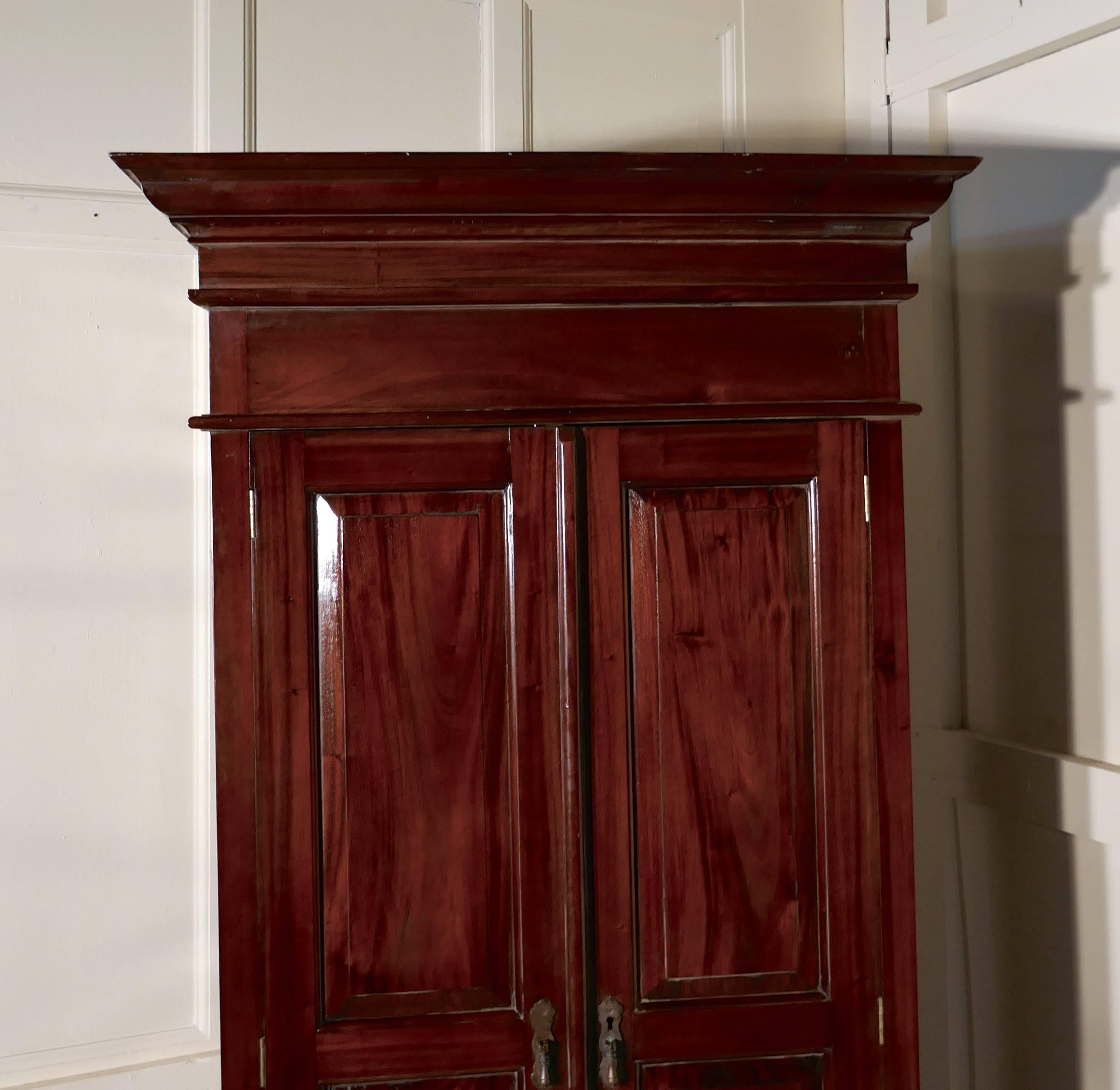 A solid mahogany shelved armoire hanging wardrobe 

This is a very attractive piece, the mahogany wardrobe is a good quality piece, it has two panelled doors, two drawers at the bottom and an outward sweeping cornice

The interior has adjustable
