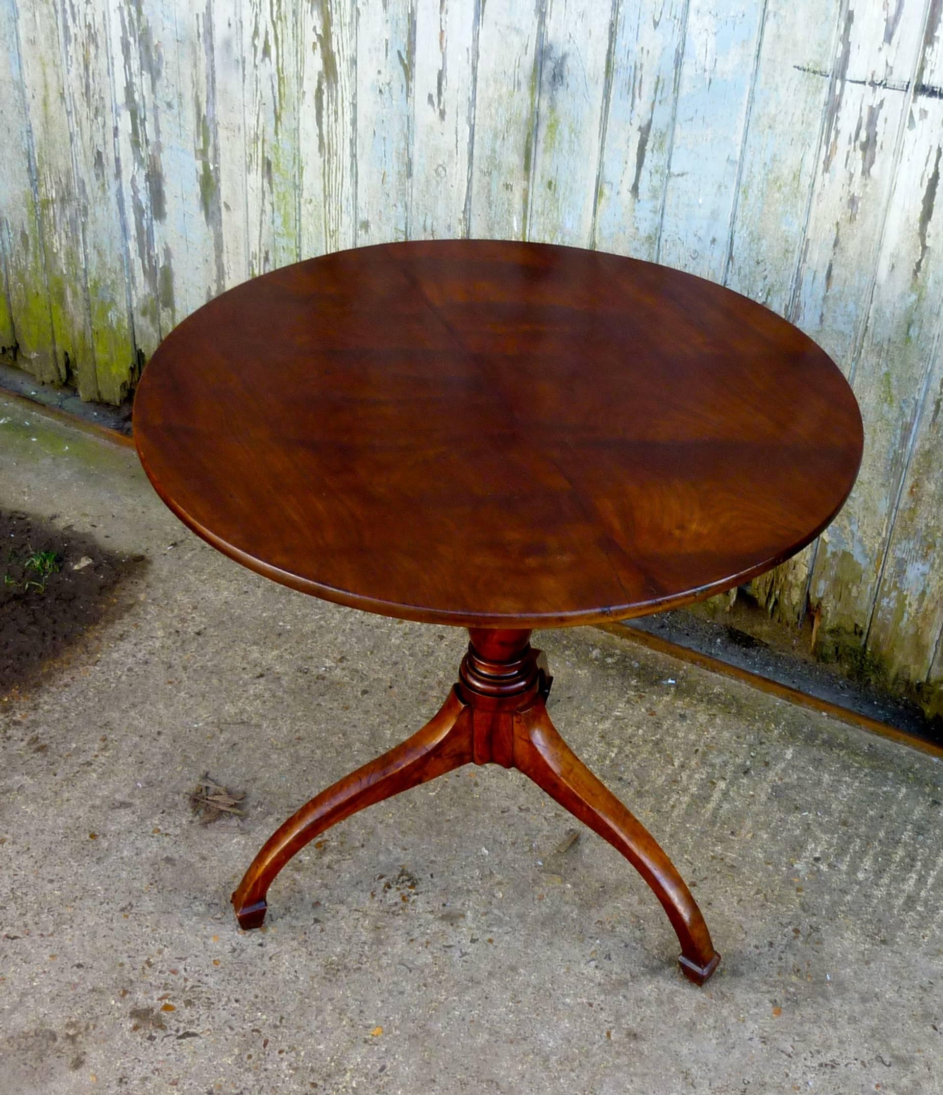 Georgian yew wood tilt-top table

This lovely table it stands on a three footed base and has an elegant shaped centre leg
The superbly figured yew top tilts easily, on the cherry leg and is held in place by a small catch below
The table is in