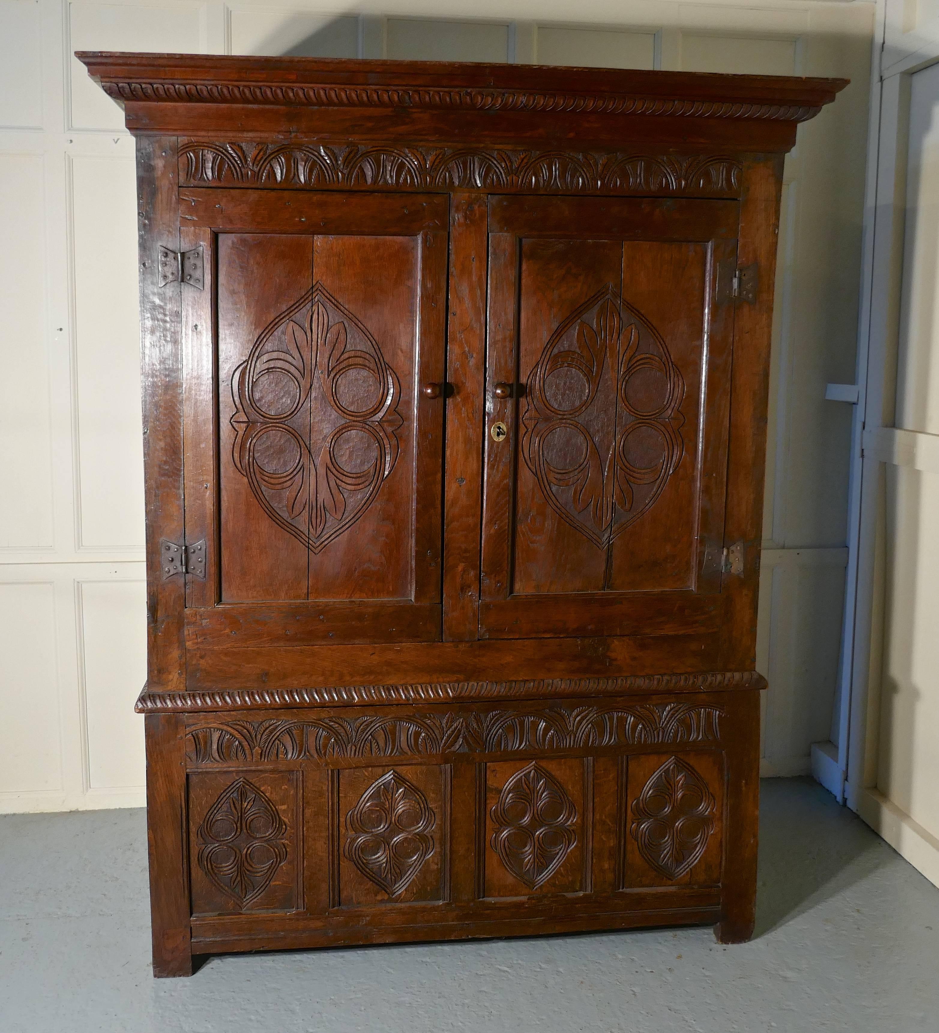 17th century welsh oak slab side housekeepers cupboard, wardrobe

This Old and roomy cupboard is made in solid oak and needless to say it is very heavy, luckily it does come into two pieces for transportation
The two large carved panels doors