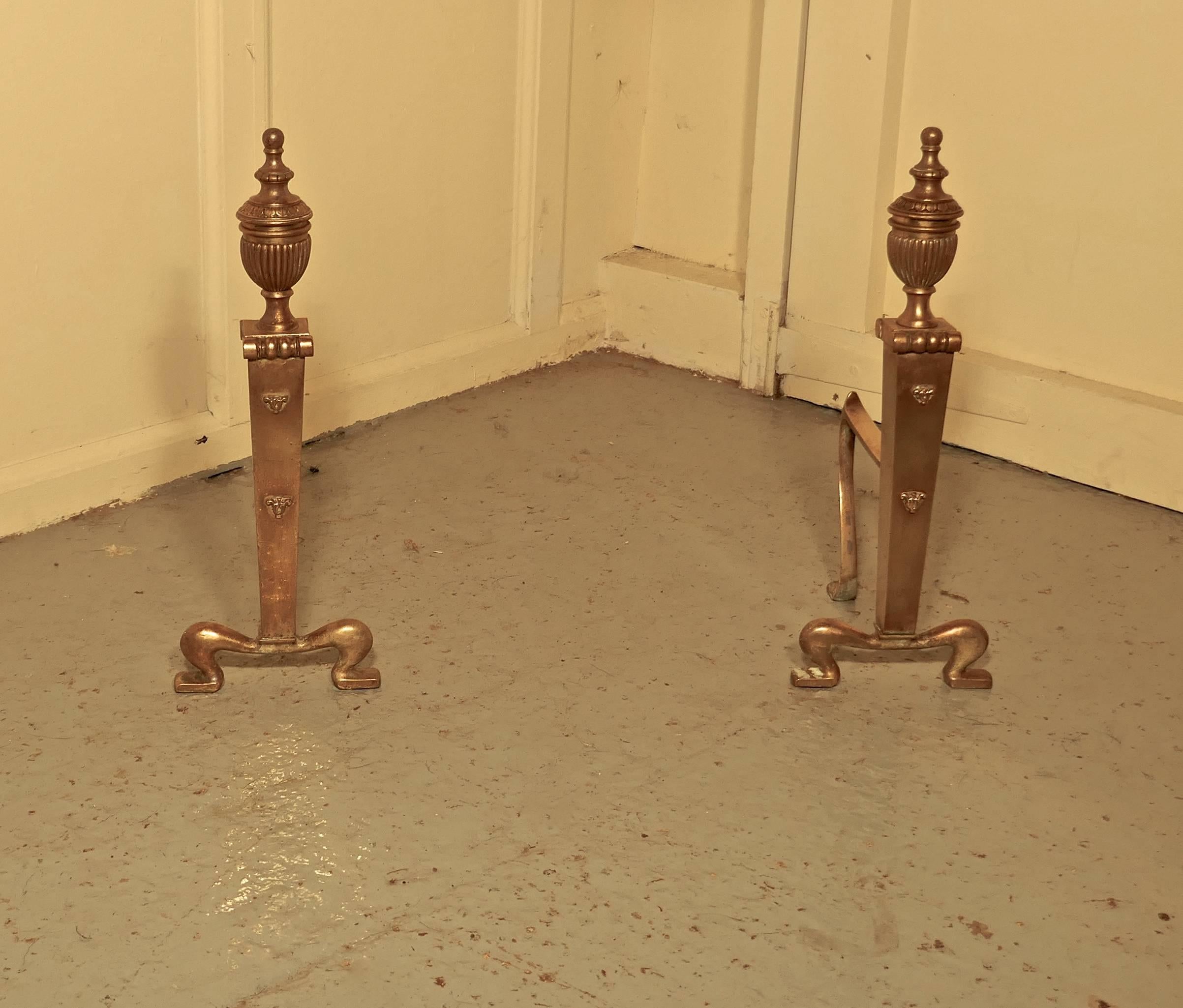 An elegant pair of 19th century brass andirons or fire dogs

This very attractive pair of brass andirons, they have a classical look with tall urns on the top and attractive scrolling feet

The andirons are measure: 17” high, 16” long and 9”
