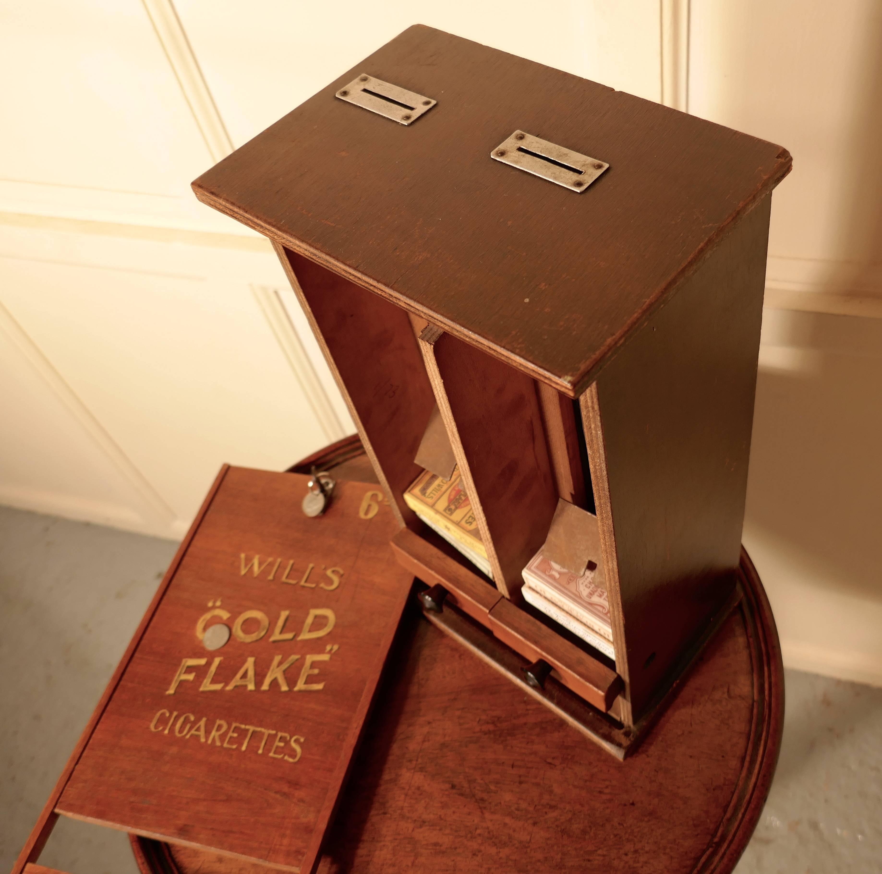A hotel reception cigarette dispensing machine, Wills Gold Flake

This little machine would have been specially made for a hotel or similar, so that the staff could provide cigarettes to out of hours customers. The machine is made in wood and has