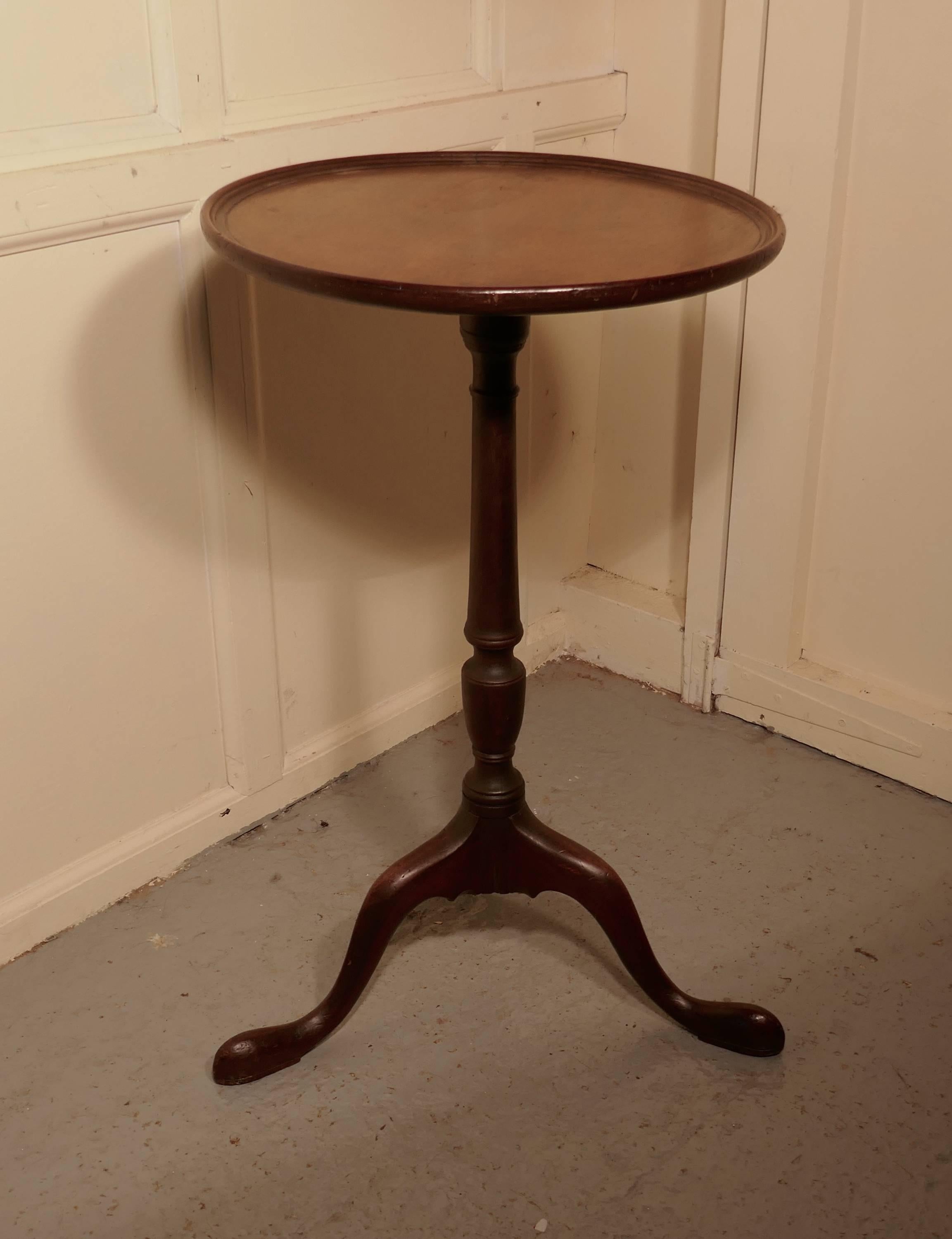 Small 19th century mahogany wine table

This lovely table it stands on a three footed base and has a attractive turned centre leg
The one piece round mahogany top has a dainty raised and moulded edge
The table is in good condition there are some