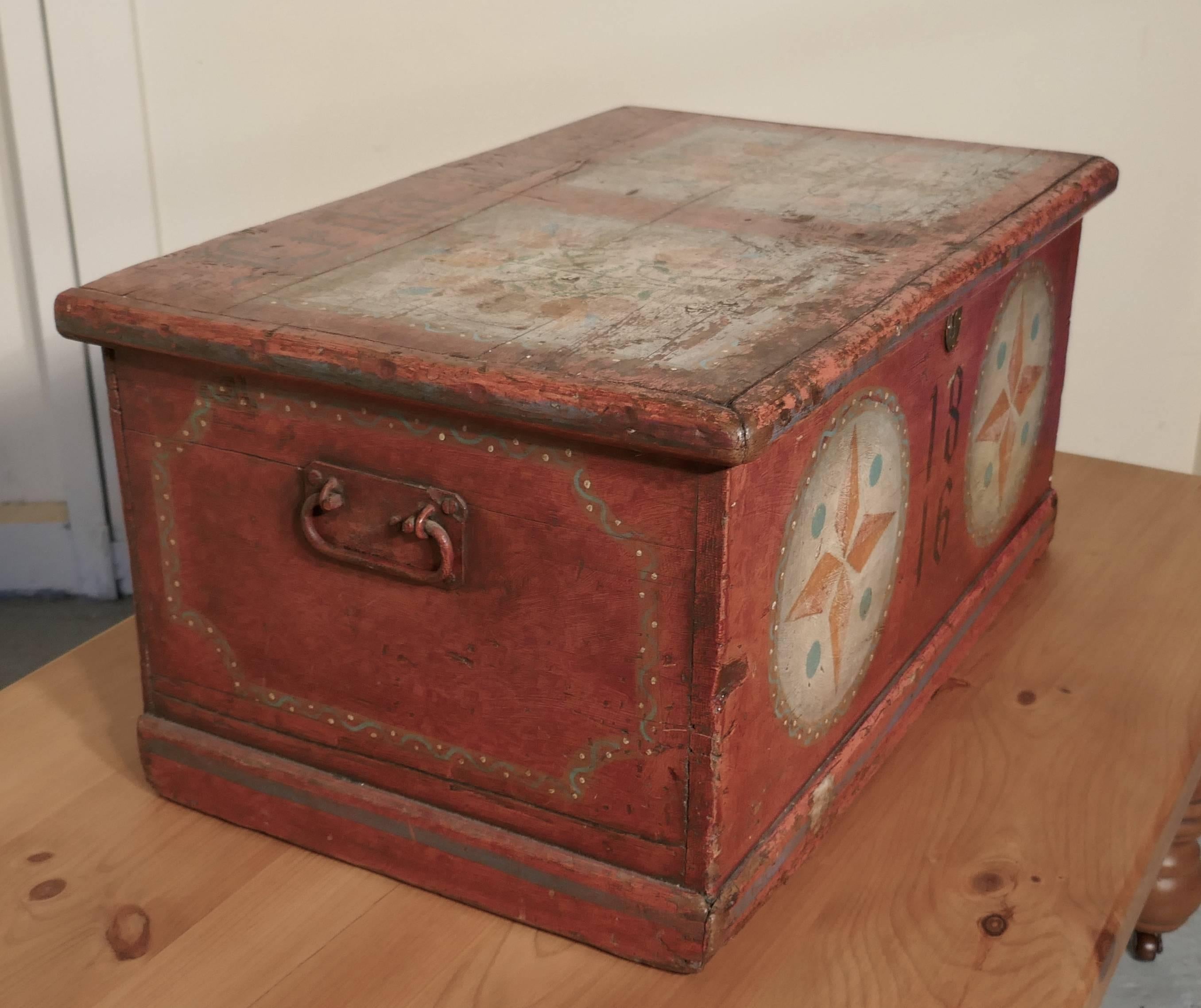 European painted pine chest

The chest has been painted, it has the name Erika Rindt, at the top and the date 1816 painted on the front, the chest is painted with flowers and patterns on a pink/rust colored background

The chest stands on a