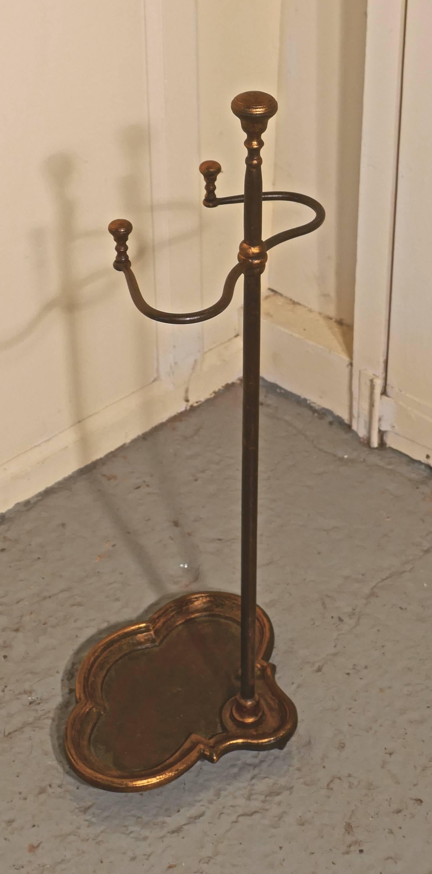 Art Nouveau cast iron and gilt walking stick stand or umbrella stand

A charming piece with an unusual shape, the heavy iron base has a trefoil shape and this is also the drip tray this is mirrored at the top with twisted wrought iron which holds