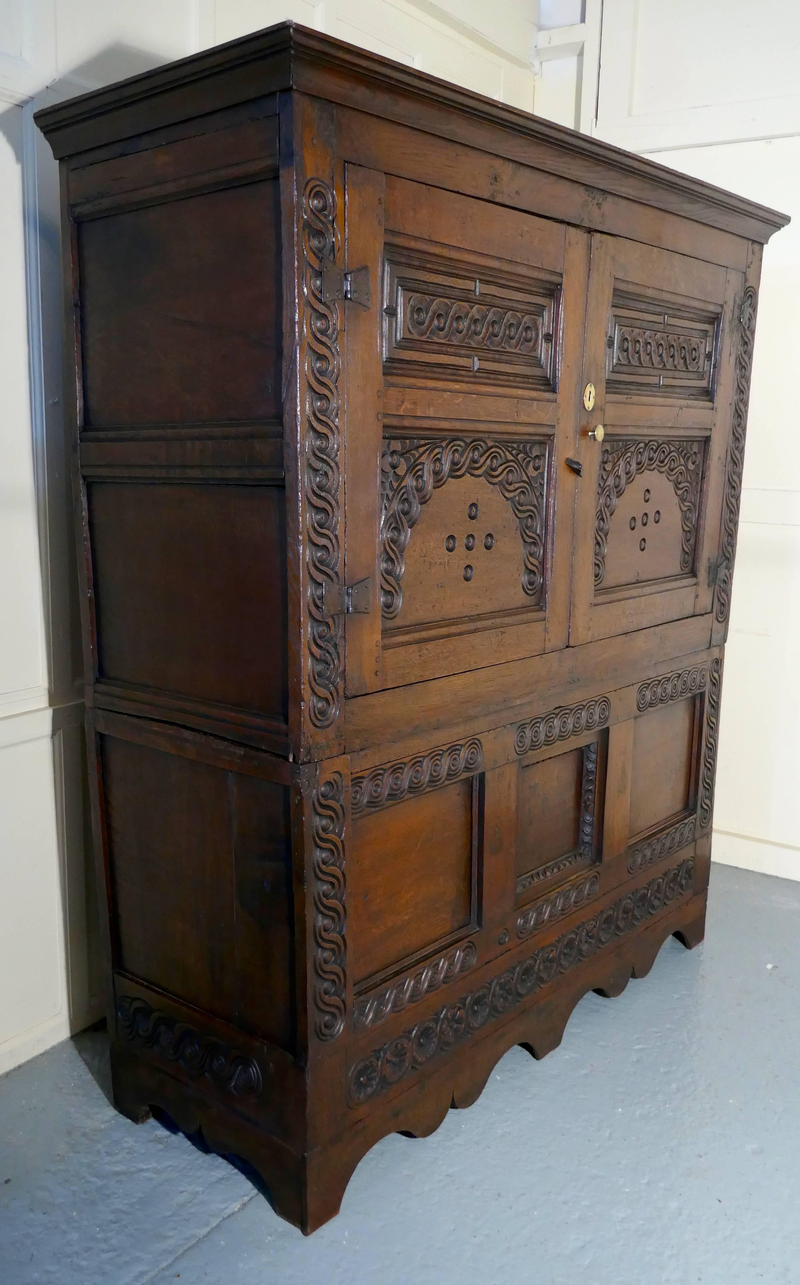 17th century Welsh oak housekeepers hanging cupboard

This old and roomy cupboard is made in solid oak and needless to say it is very heavy, luckily it does come into two pieces for transportation
The two carved panels doors enclose a deep