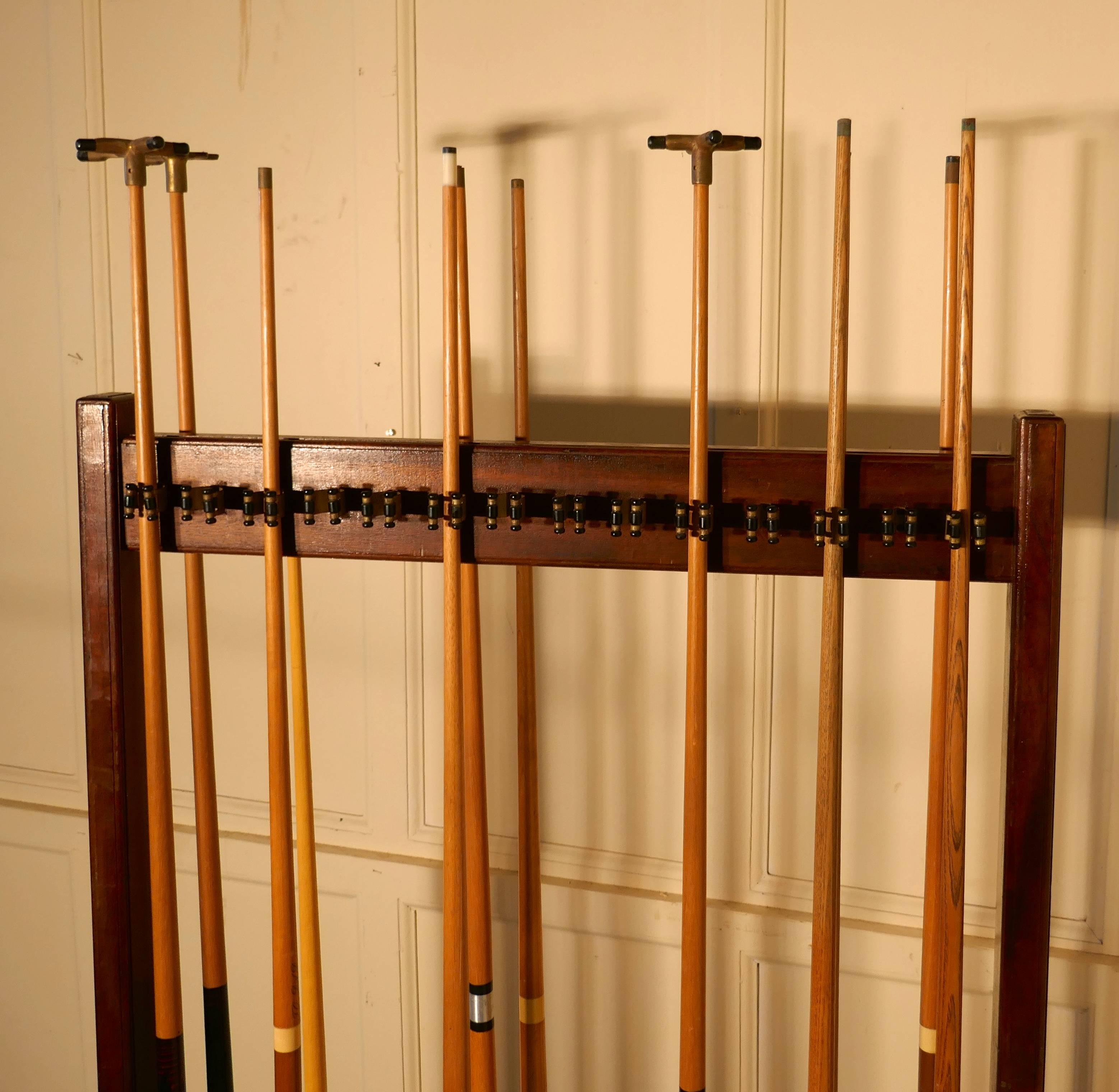 Large 19th century mahogany 28 snooker cue rack and cues

This is a superb piece and a must for the games room, this large mahogany stand is double sided, it can accommodate up to 28 cues, the cues sit in a base lined round groove, and is held at