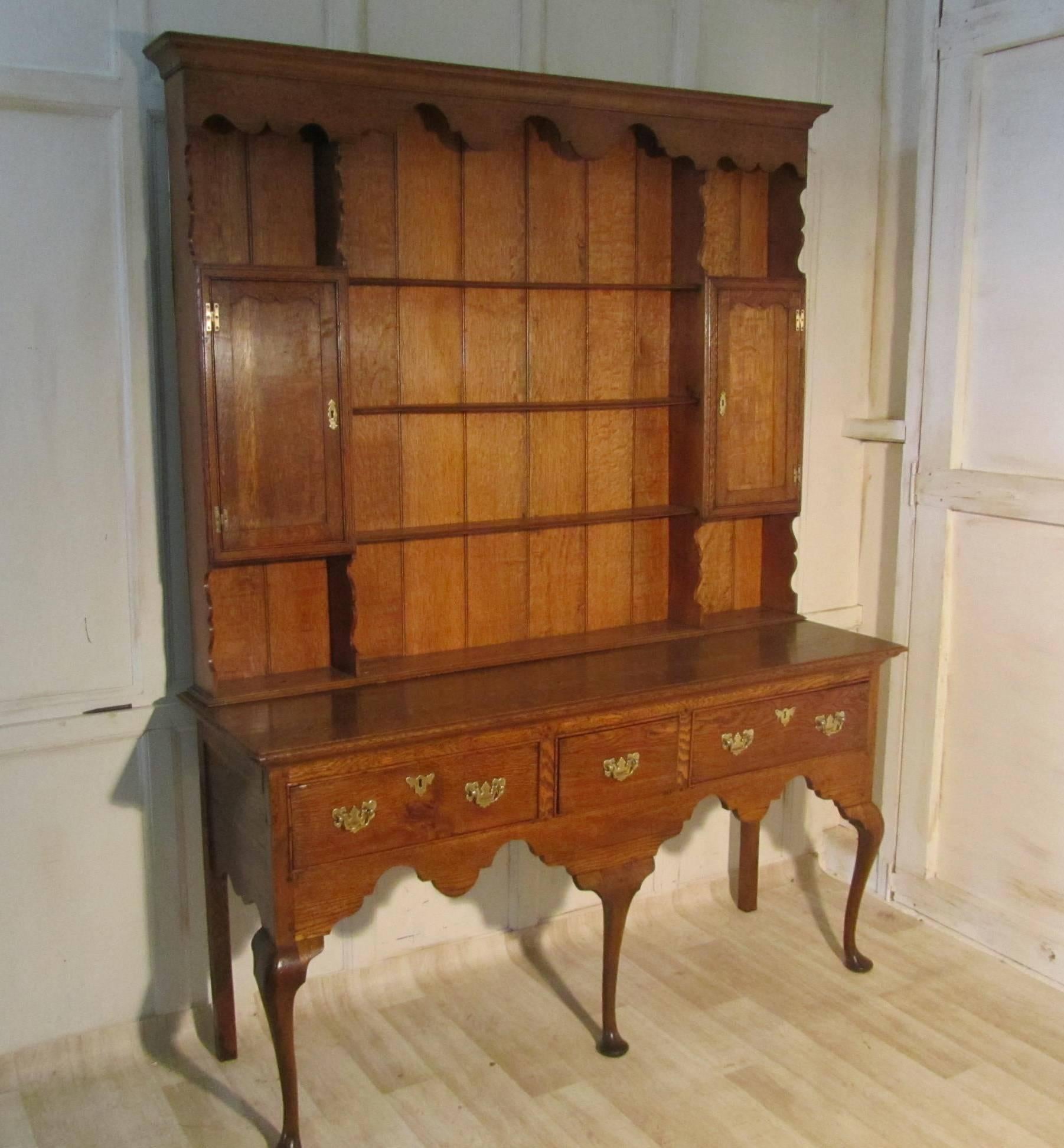 An exceptional Georgian country oak dresser 

A superb piece of period oak, with hand cut mouldings and back boards
The base of the dresser has three drawers with a scalloped frieze below and it stands on elegant pad feet
The upper part of the