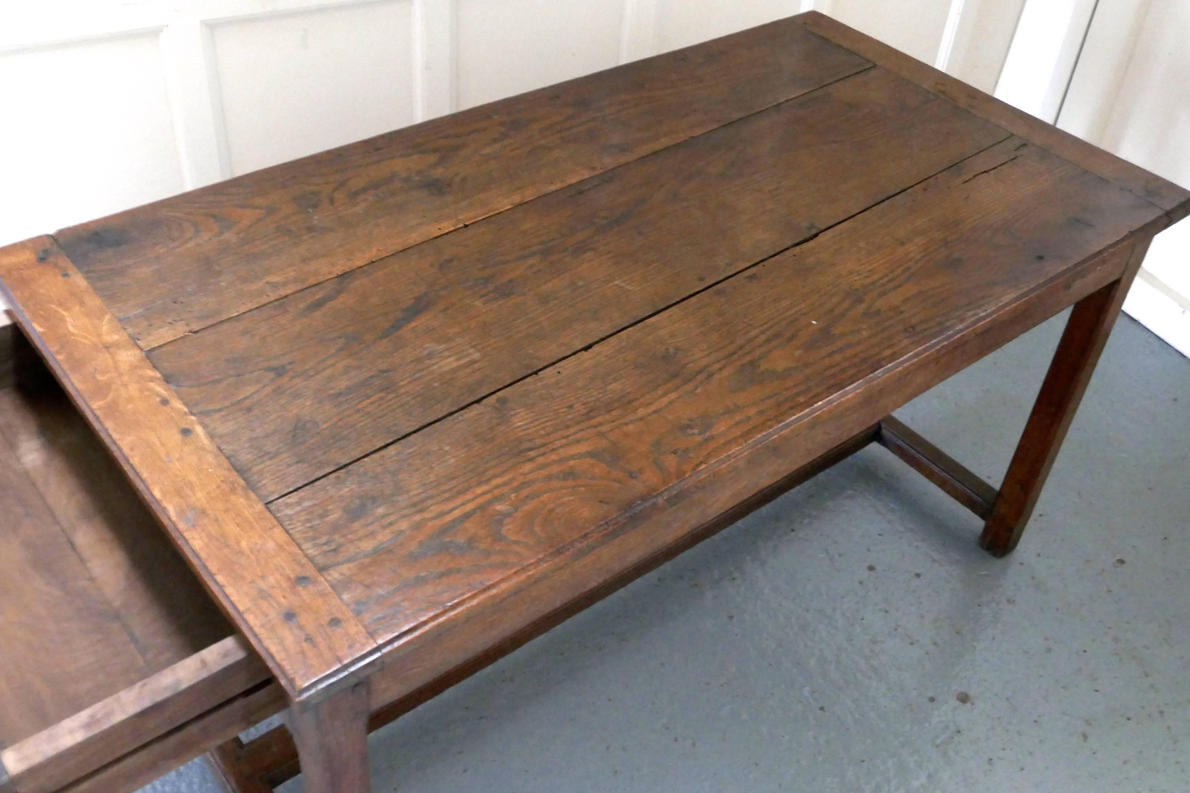 Early 19th century French chestnut farmhouse table 

This is good honest farmhouse table and it is an unpretentious piece is aged and naturally distressed with a superb patina 
The top of the table is made from three thick planks and has cleated