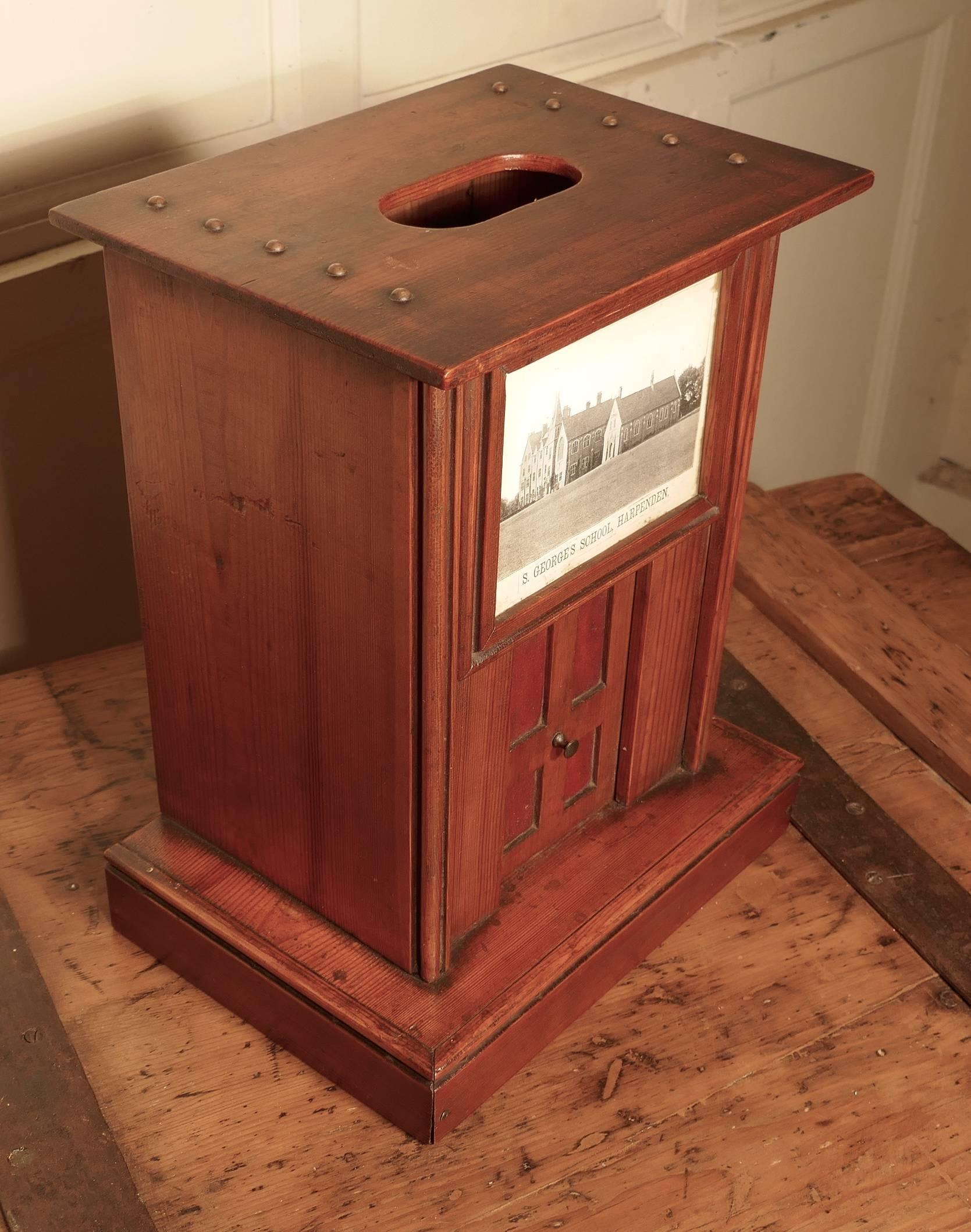 Victorian school house letter box, post box.

The post box is a very attractive piece, it has a slot in the top for letters and a picture of St Georges School Harpenden on the front above a pretty little four-panel door which has red leather in