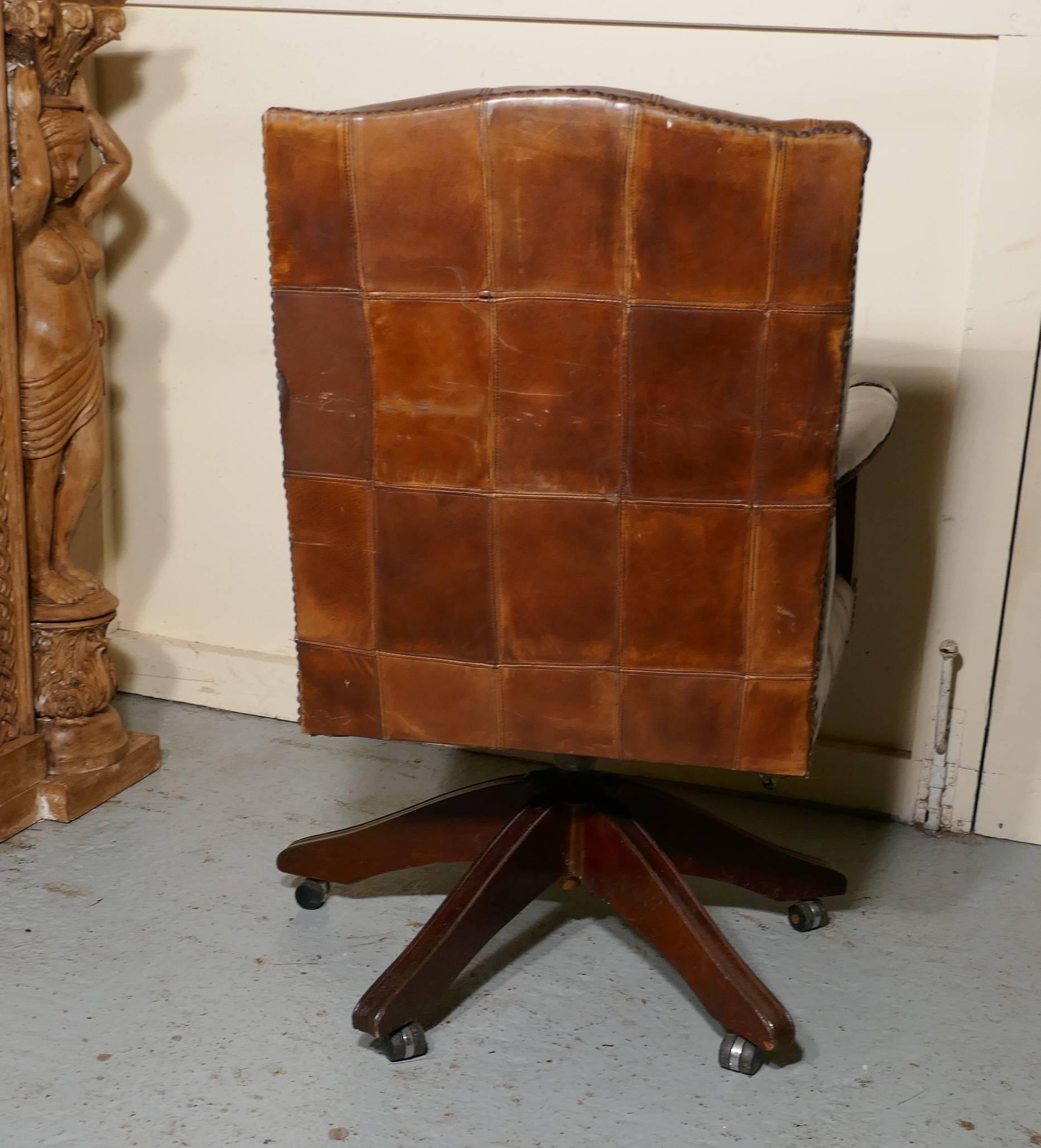 Chesterfield leather library or office desk chair

This is a wonderfully comfortable desk chair, the high back of the chair is covered in deeply buttoned Brown leather with brass studs, as is the seat and arms
The arm fronts have carved roundels
