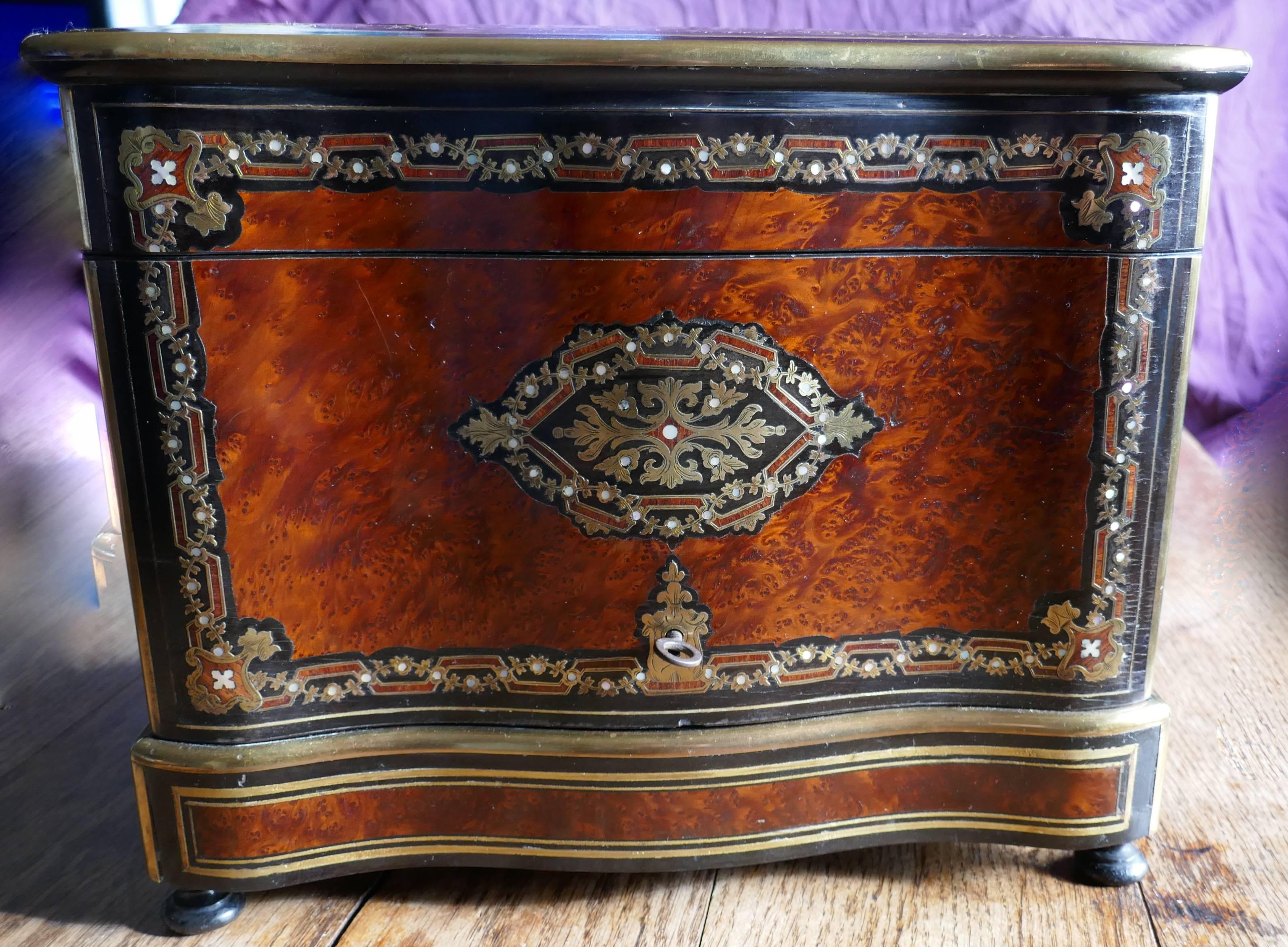 Inlaid Cave de Liqueur by Maison Alphonse Giroux, circa 1830

This is a wonderful piece of French craftsmanship it is a French inlaid tantalus or Cave de Liqueur with four decanters and 16 shot glasses, the cabinet has a serpentine shaped front,