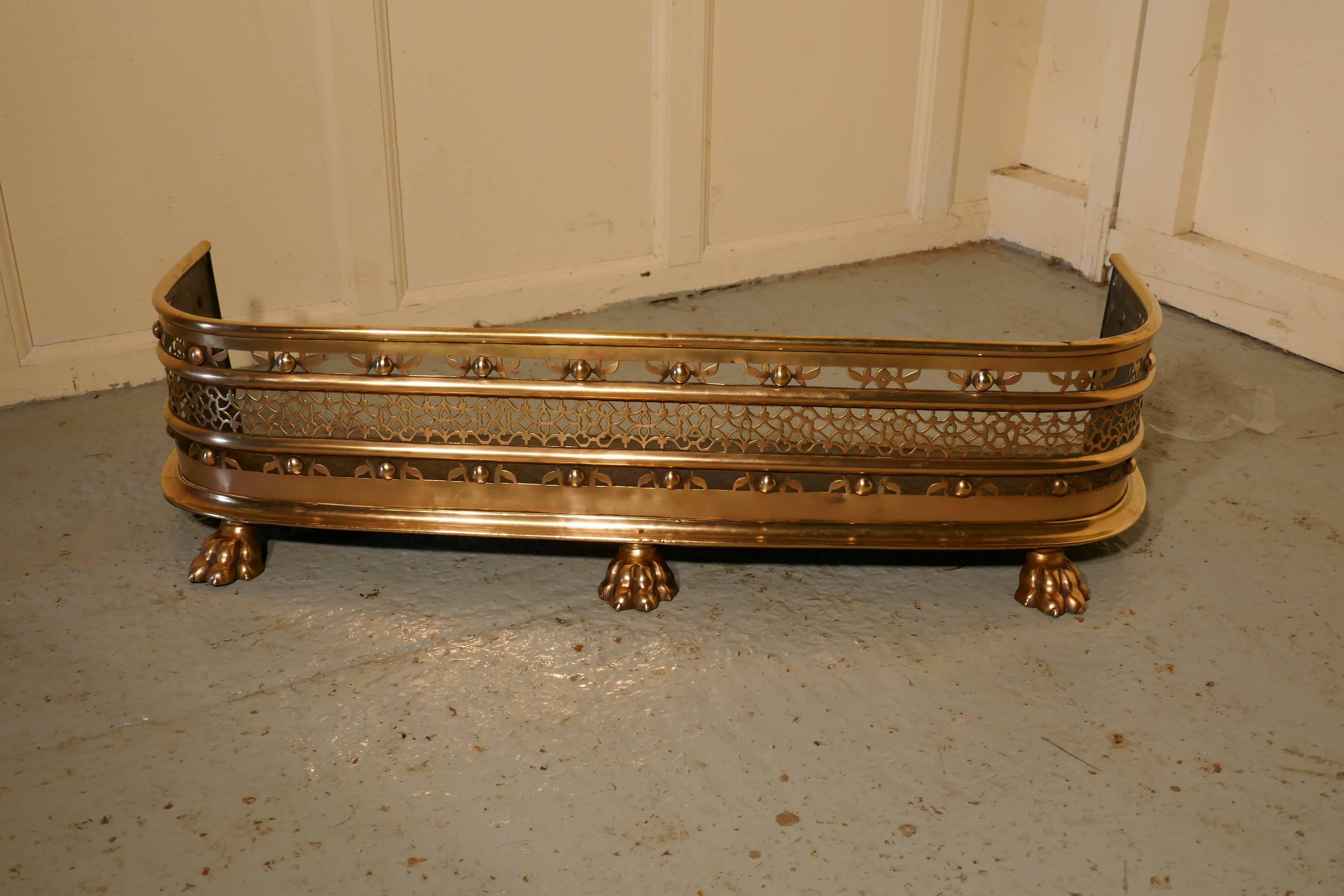 Fine quality Victorian pierced brass fender

This is a Victorian pierced brass fender it has, an elaborate pierced decoration, an iron base and stands on large lions paw feet
The fender is in very good condition it is 11” high, and 36” long and