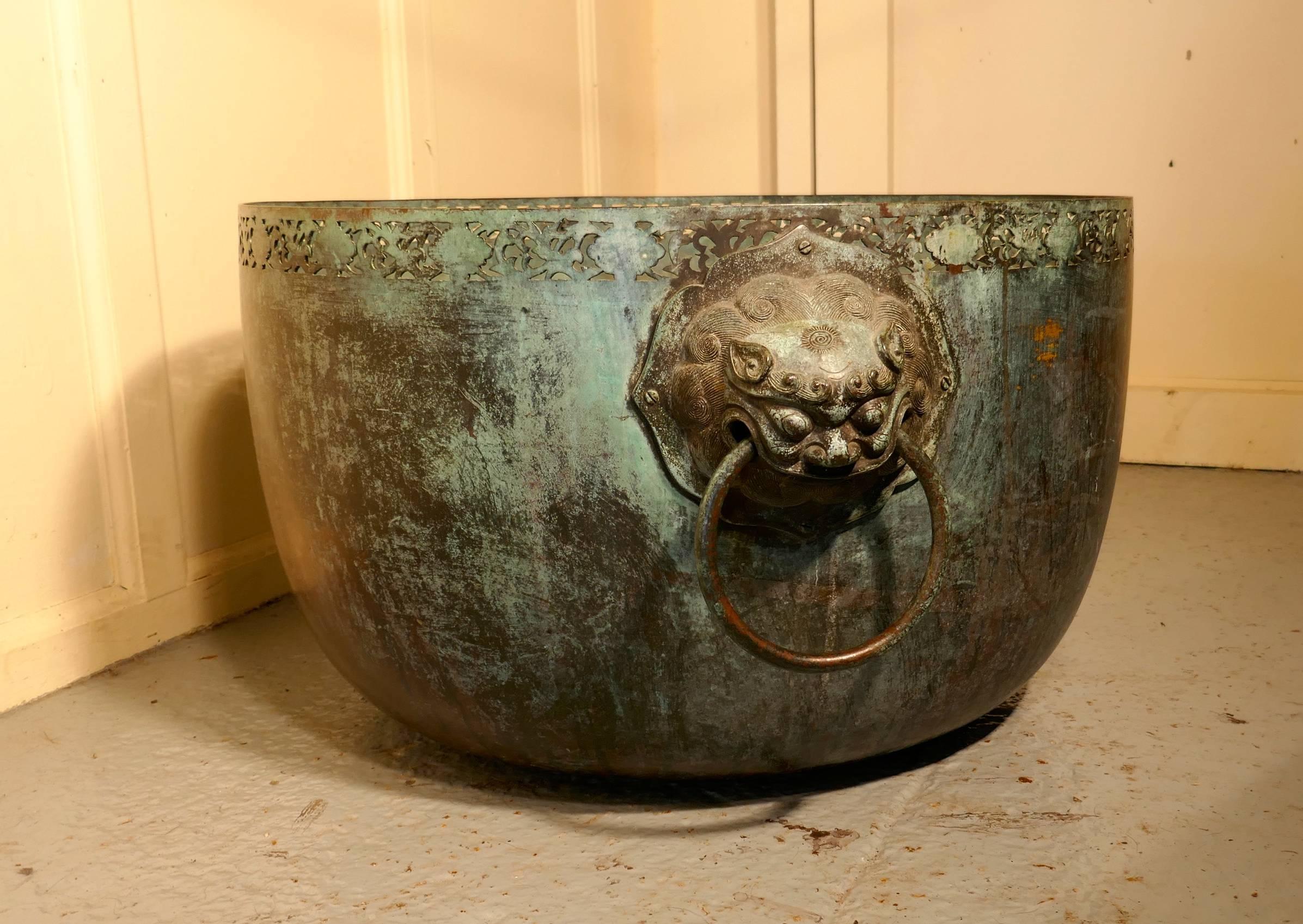 Large Bronze Temple Water Bowl with Lion Dog Mask Ring Handles 1850

A superb piece, this Bronze bowl in authentic condition, it has not been taken back or polished. The bowl has a pierced border around the top edge and it has very large Temple