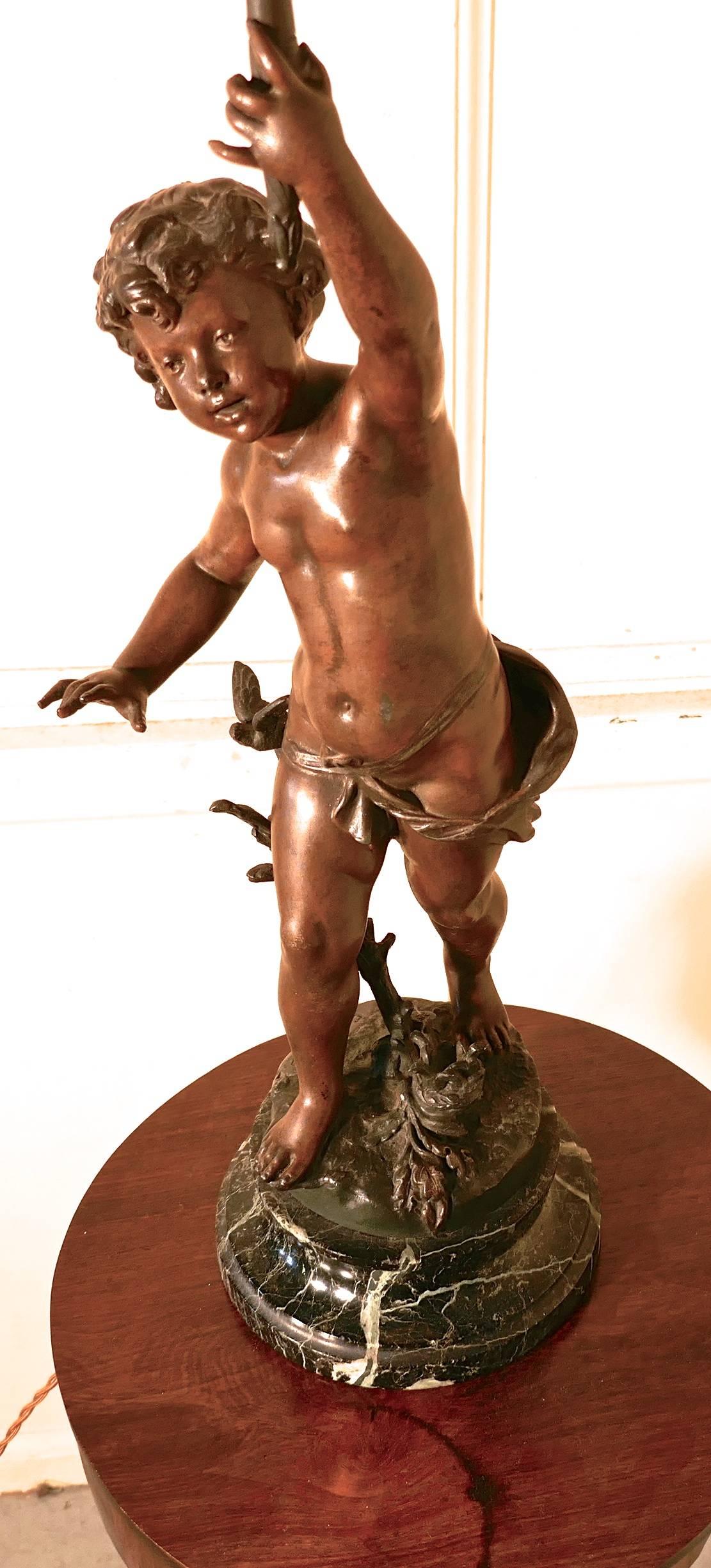 A bronze lamp of a cherub or putti after Ernest Justin Ferrand

This charming piece dates from the last half of the 19th century, and signed FERRAND. The figure has a superb patina and is set on marble, the little cherub has branch entwined in his