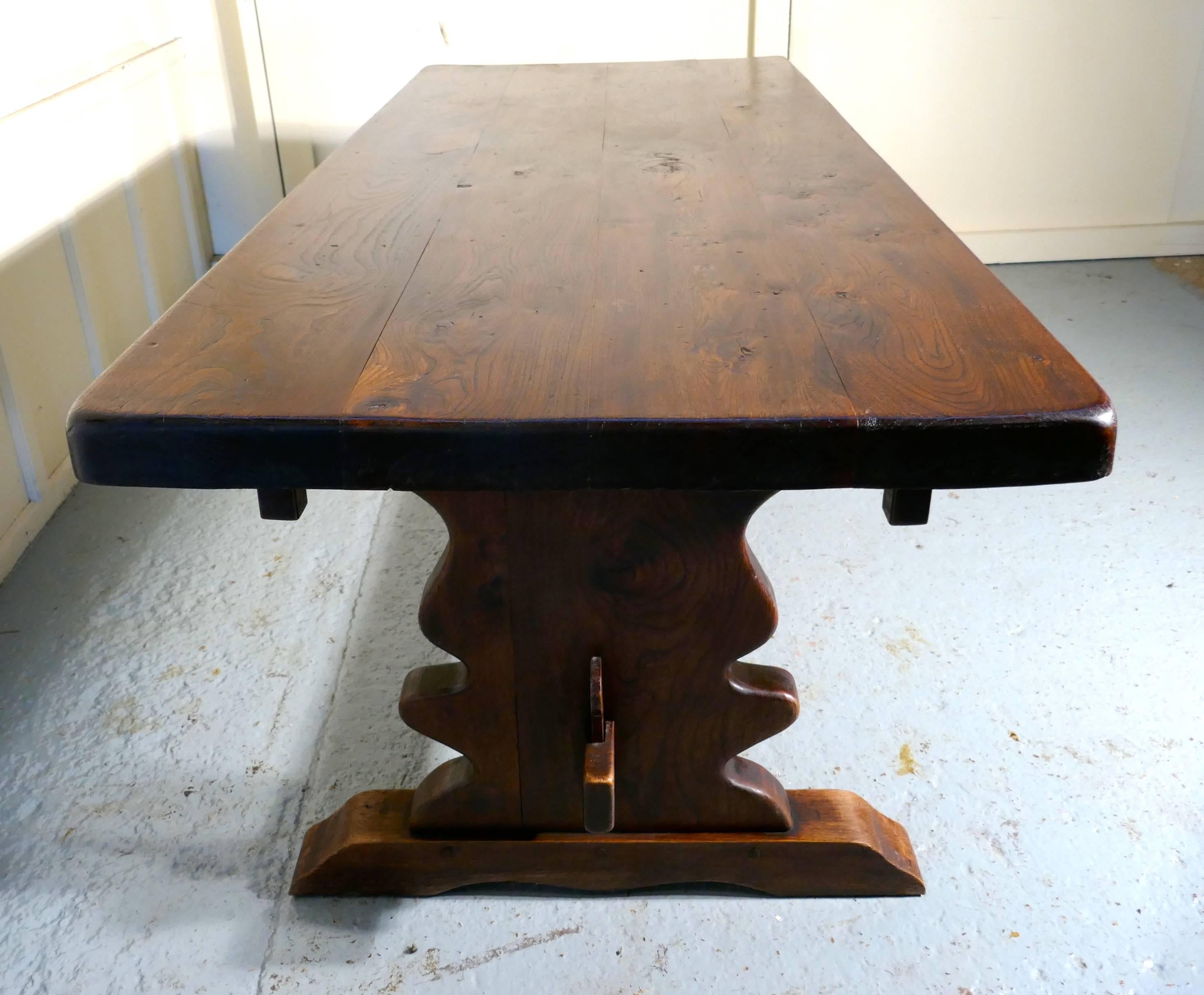 A large French elm refectory extending table

This is a fantastic piece of 19th century elm furniture, the top is made from 4, 3” thick planks, the table has a very good natural patina 

The table is a typically French style known over there as