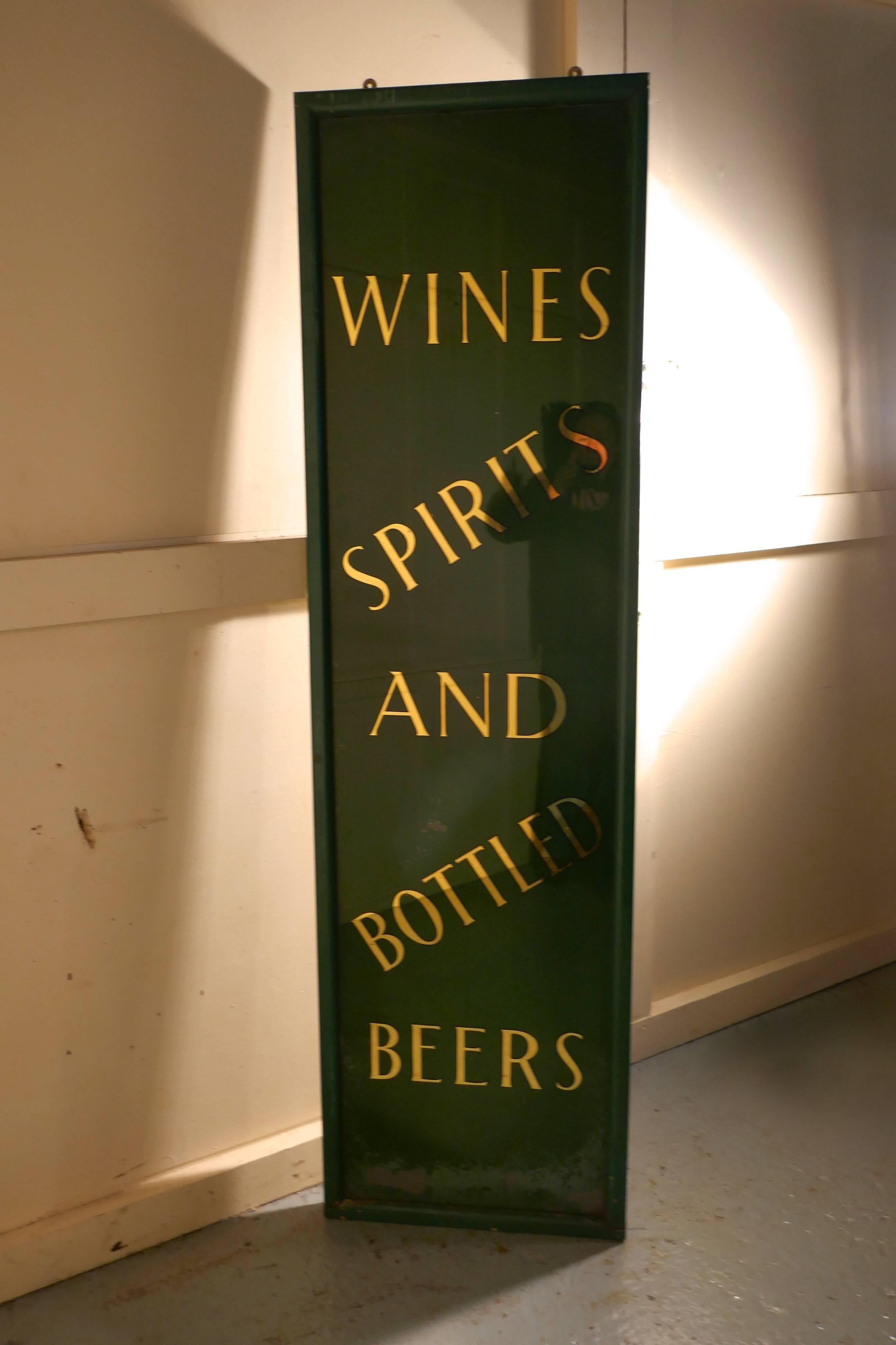 19th century pub mirror advertising sign

This is a great and authentic piece, the sign has gold mirrored lettering on green glass, the glass is set in a green frame and is advertising, wines spirits and bottled beers
The sign is in generally