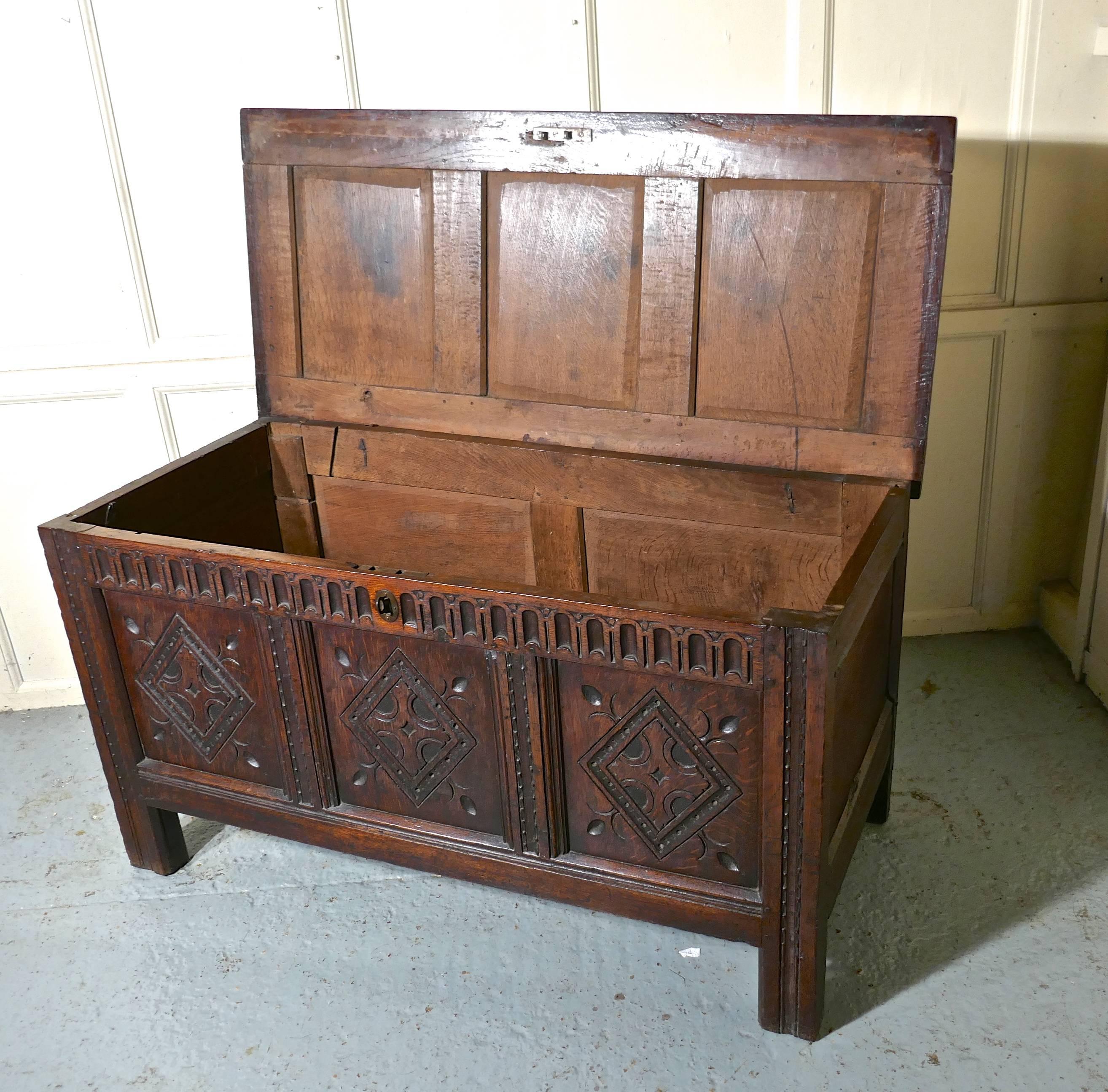 17th century carved oak coffer, with key

This is a lovely old piece, with a superb patina, the chest has three geometrically carved panels on the front set into carved borders and on the heavy top of the coffer there are 3 deep moulded panels