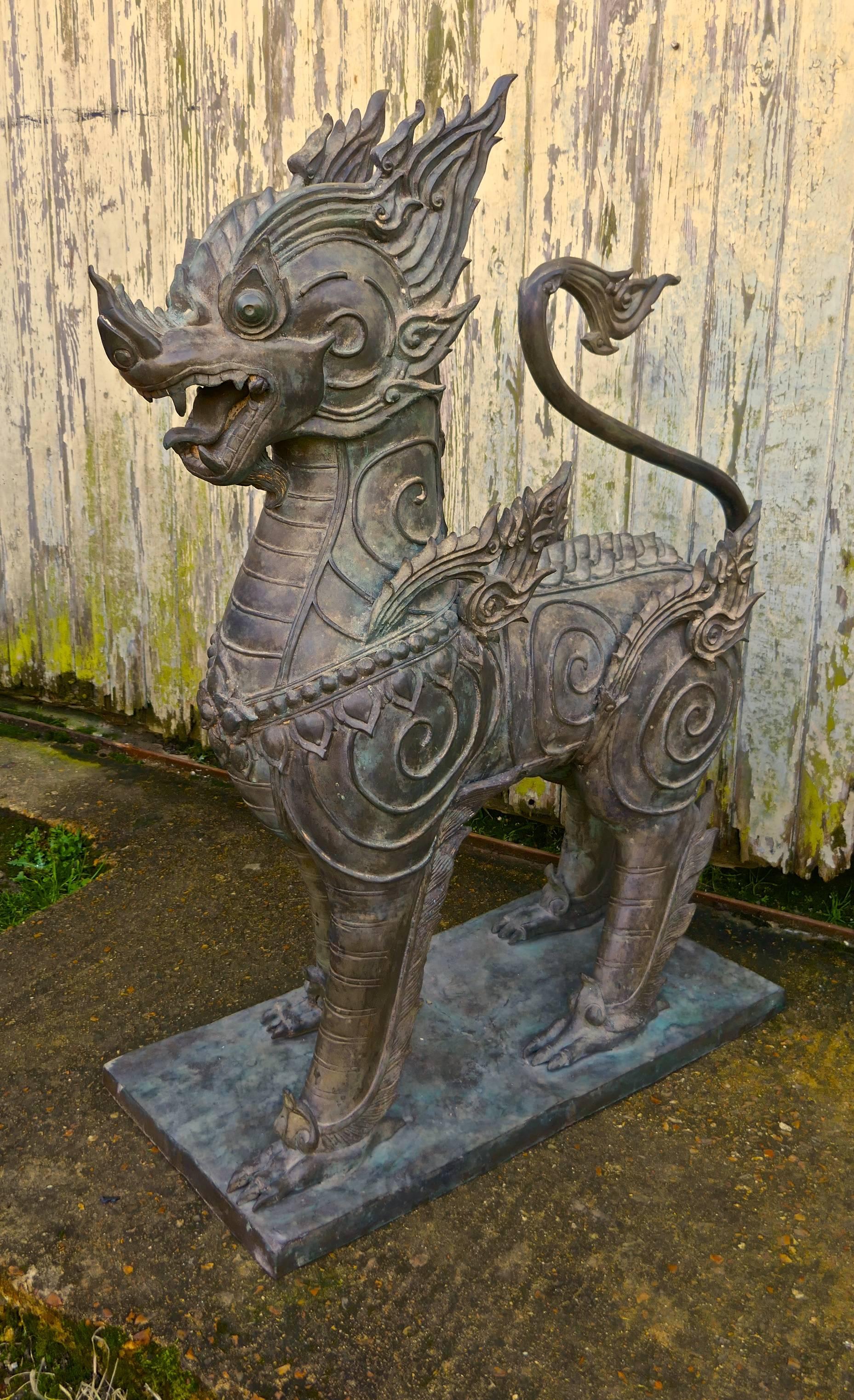 A pair of large bronze Thai temple guardian foo lion dogs

These are a very impressive pair of Singha, guardians of the Buddhist temple in Thailand, the dogs are made in bronze and are very heavy.
The dogs stand on a bronze plinth, the detail of