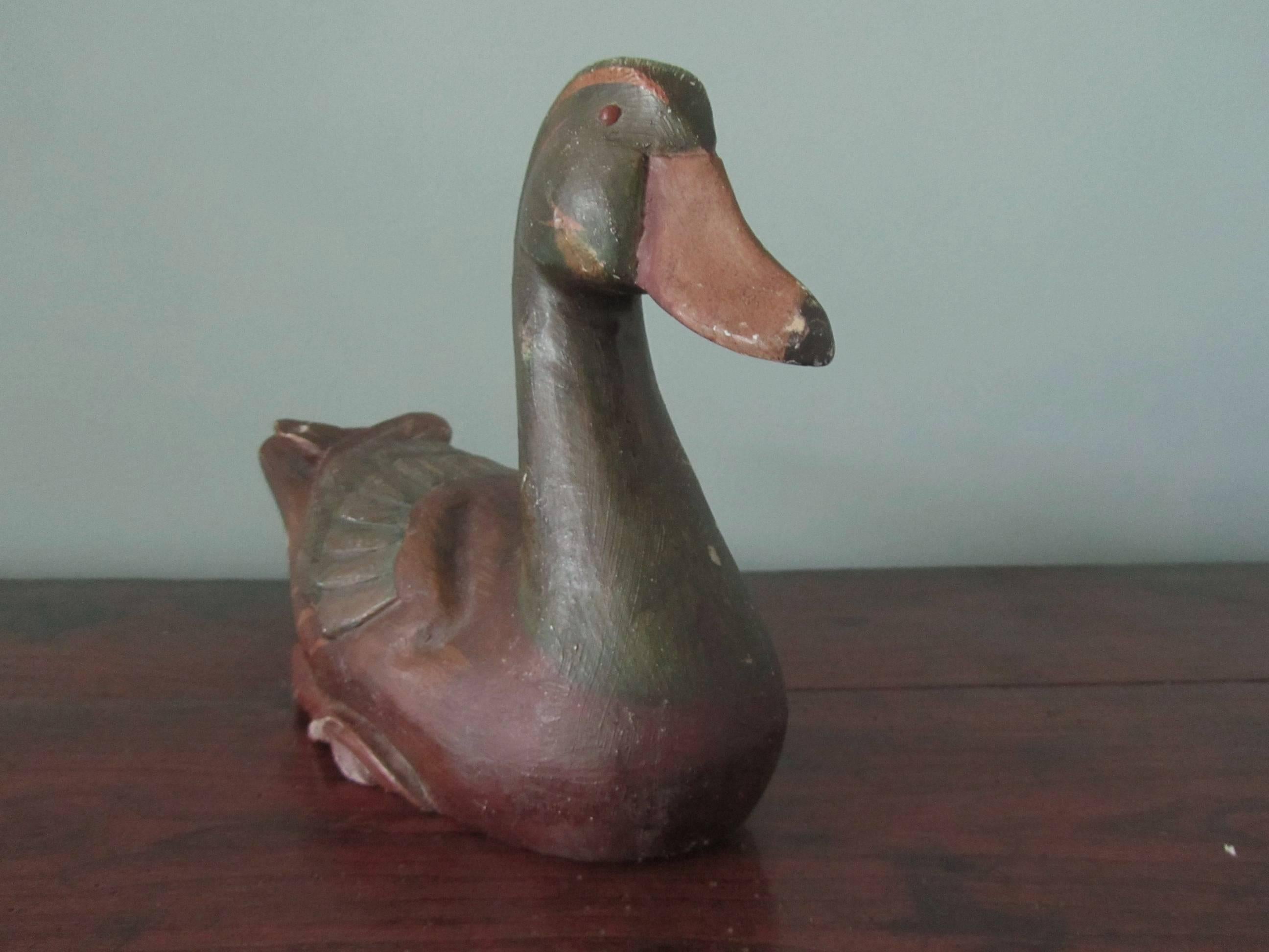 Superbly painted and carved decoy duck

This is a good 19th century decoy, he is carved from one piece of hardwood and his feathers and features are carved and painted in quite fine detail, he has red glass eyes, this is a genuine old piece and