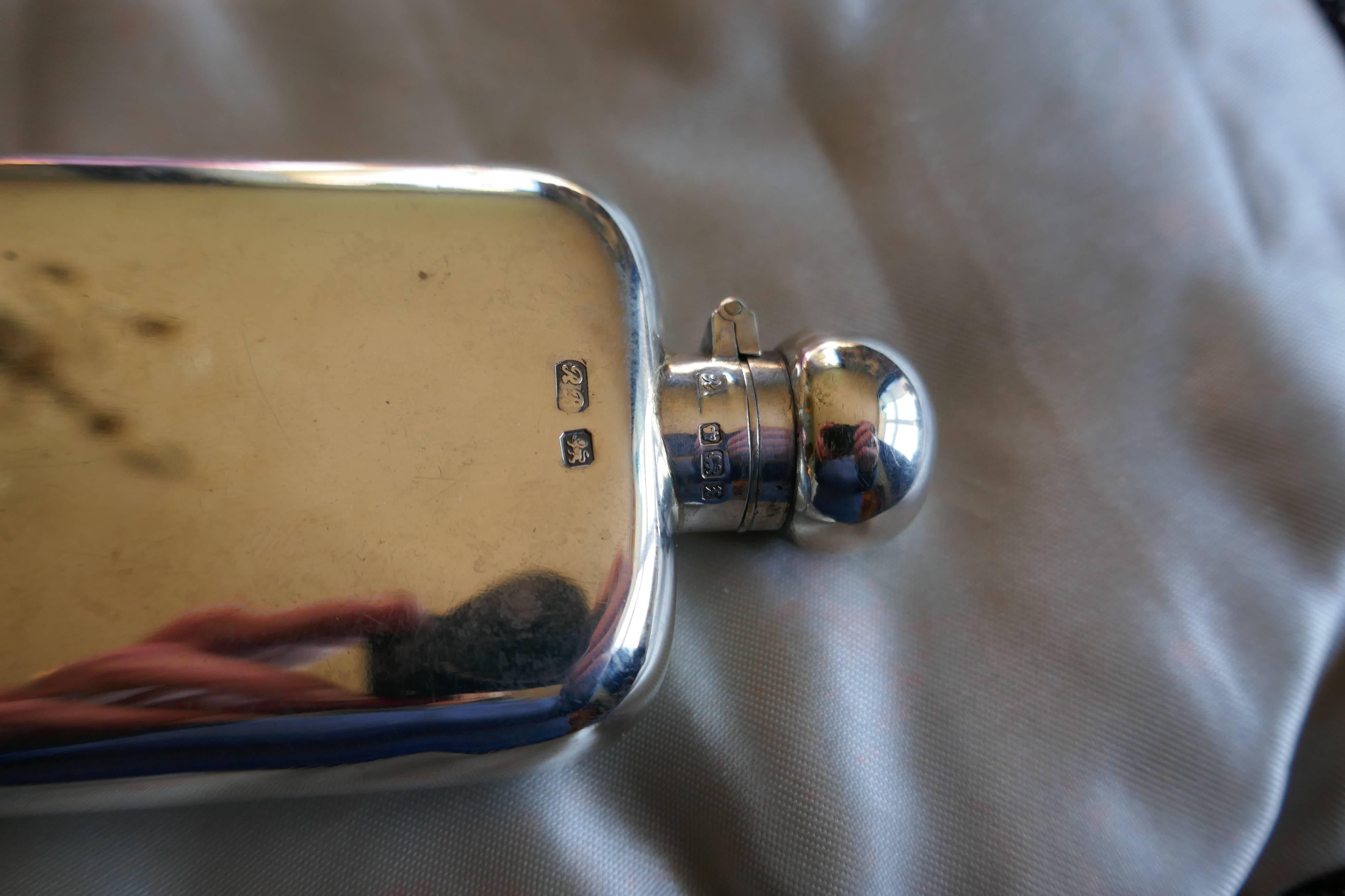 Silver Hallmarked hip or pocket flask, Richard Burbridge date 1915

A lovely piece the flask has a rounded shape with no sharp corners, making it ideal to keep in either a breast or hip pocket, the lid is hinged with a screw grip.
The flask is