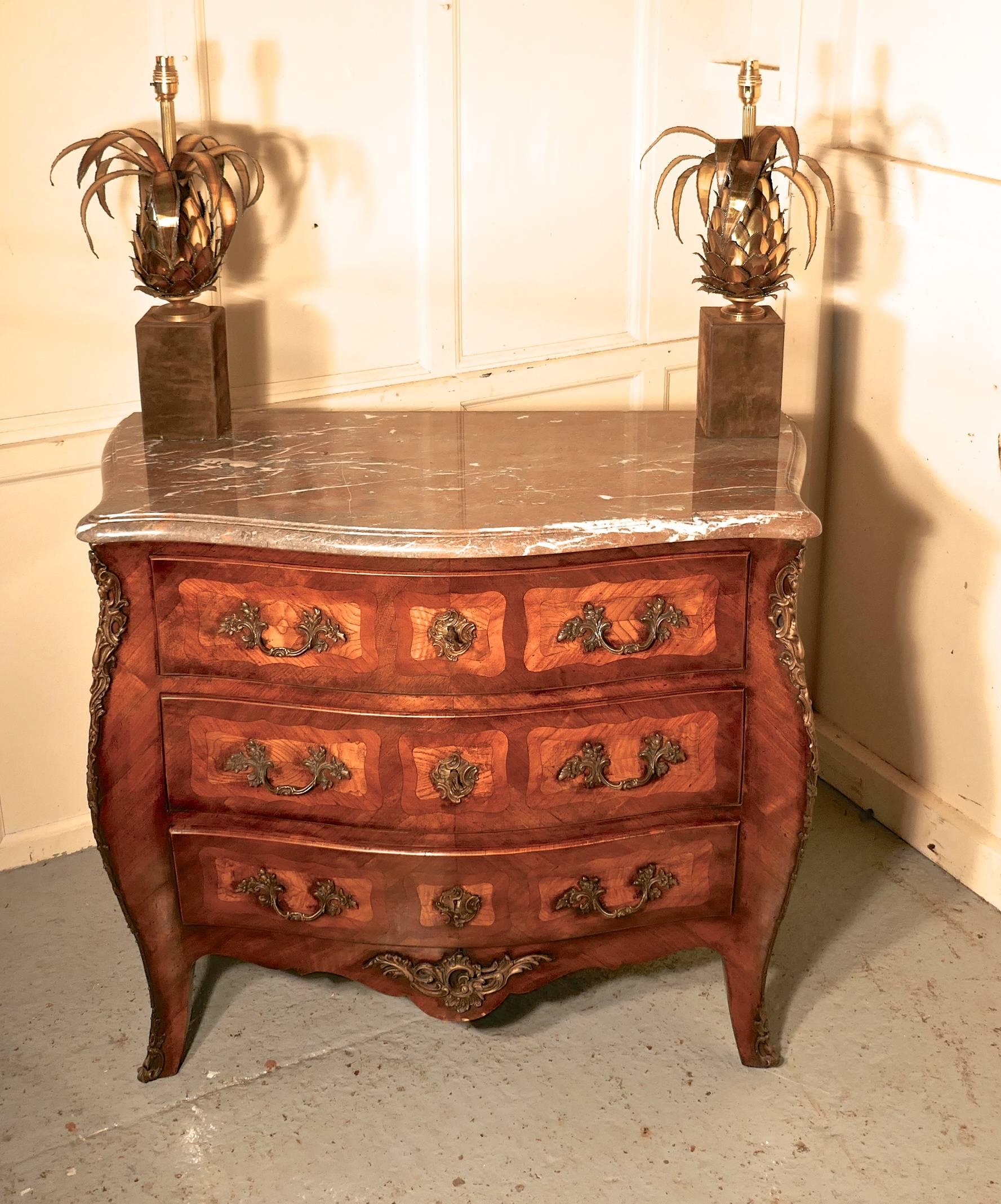 Early 19th century French Bombe Commode Chest of Drawers

This is an excellent piece, it is superb in quality and design
The chest is ash lined and made with burr elm, mahogany and walnut veneers, it has 3 long drawers and stands on sabre shaped