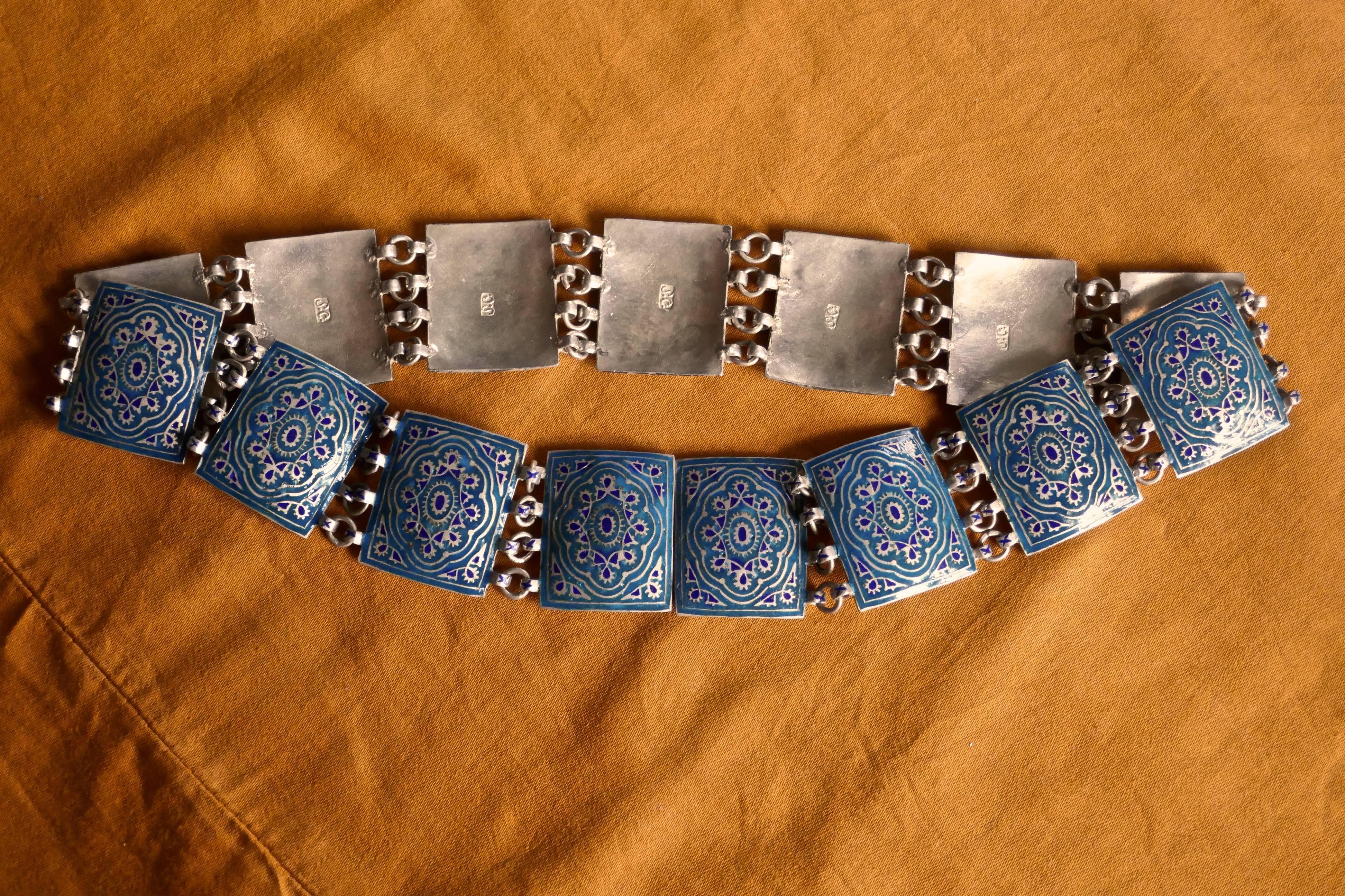 Art Deco Russian silver enamel belt

This is a lovely silver enamel belt it dates from 1910 and is made with rectangular silver enamelled medallions, these have a design in turquoise and dark blue picked out with gold
The Links are joined along