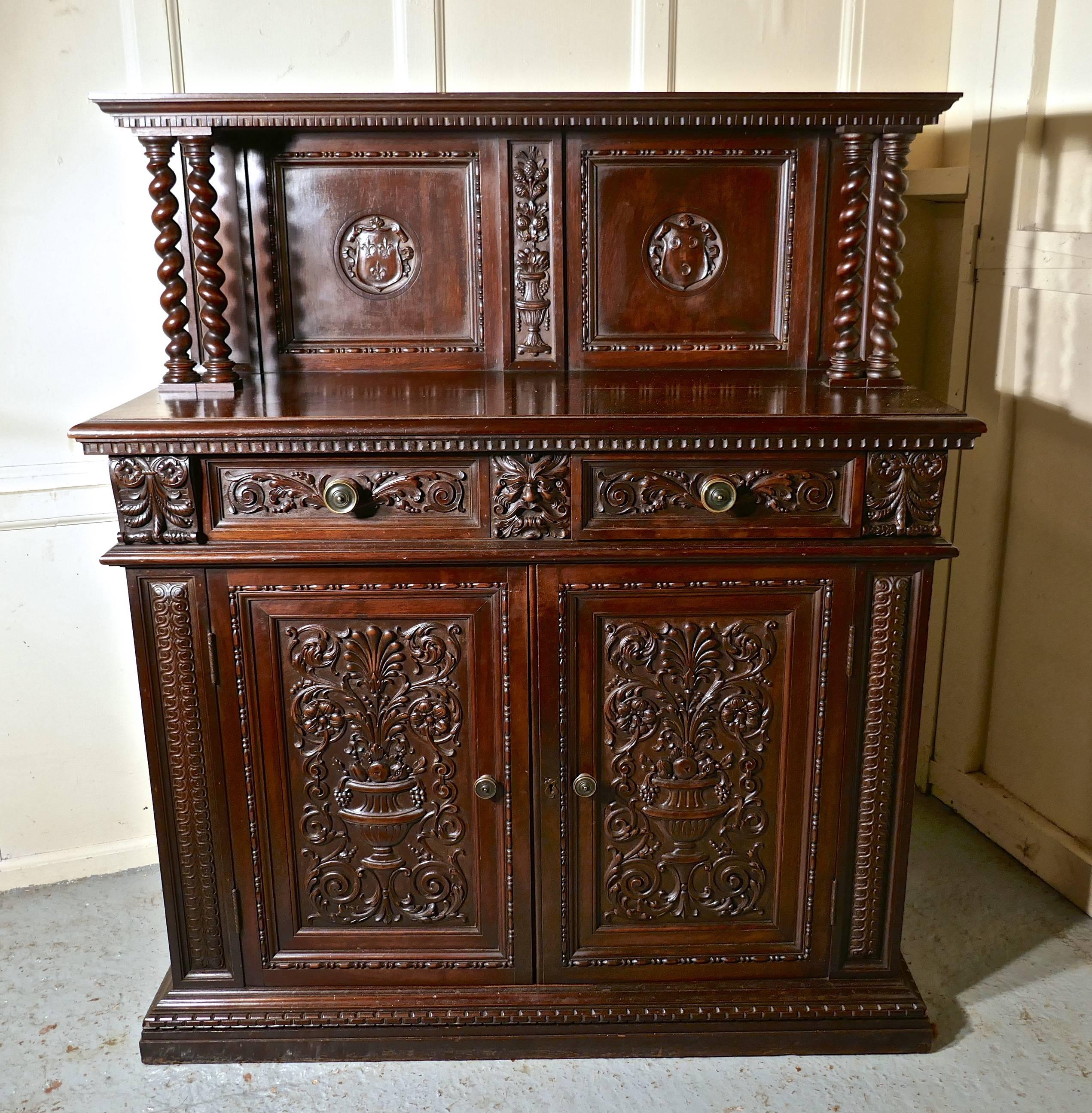 Green Man Gothic carved Walnut dresser by Edwards and Roberts

This is one of the finest carved pieces you will ever find, it was made in the second half of the 19th century by the world famous cabinet makers Edwards and Roberts.
The company did not