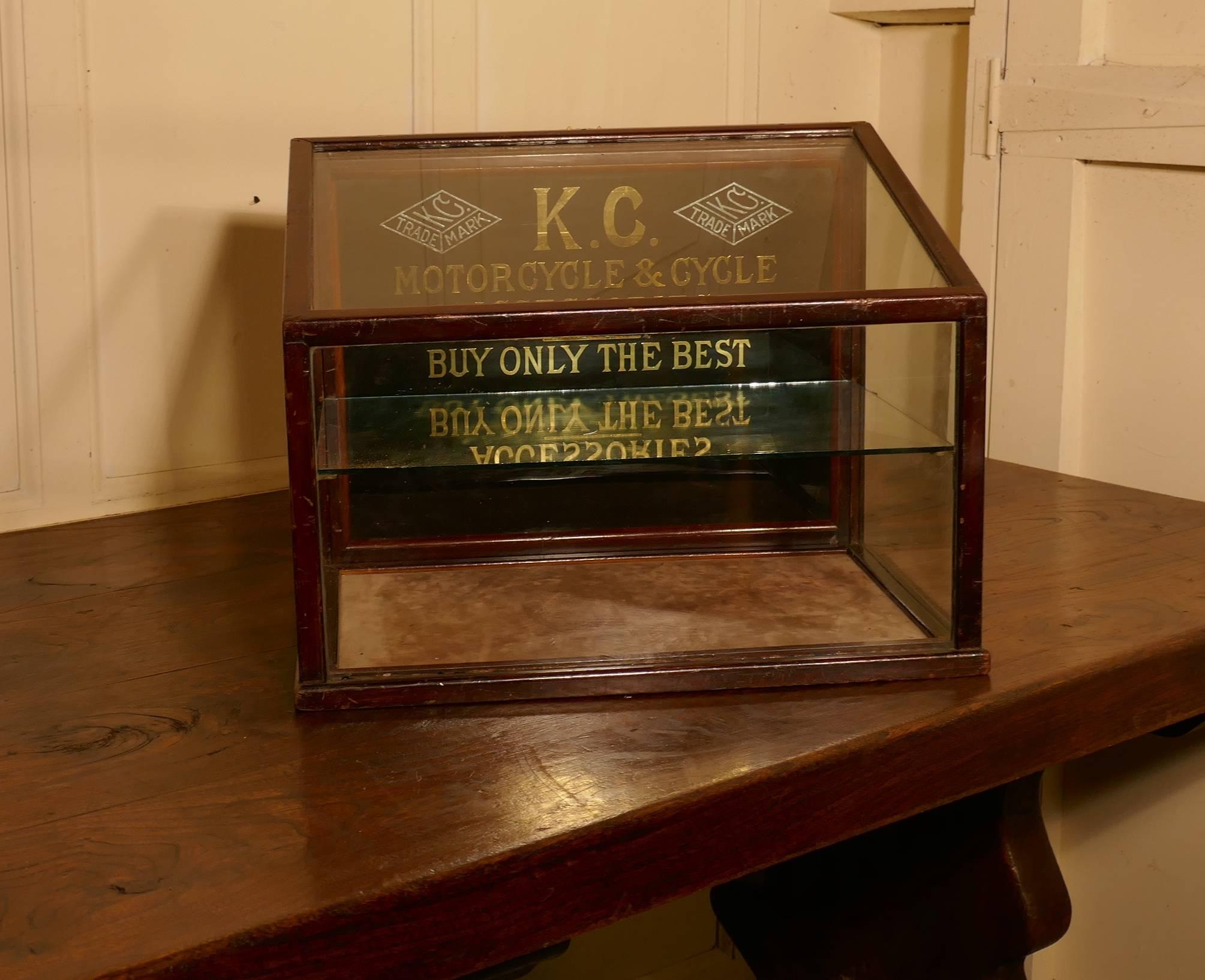 A Very Rare Kansas City, Motorcycle and Cycle Accessories Display Cabinet

A charming piece, this is a small counter top cabinet, it slopes at the top and has a glass shelf with a drop down black mirrored back with the company’s trade marks set in