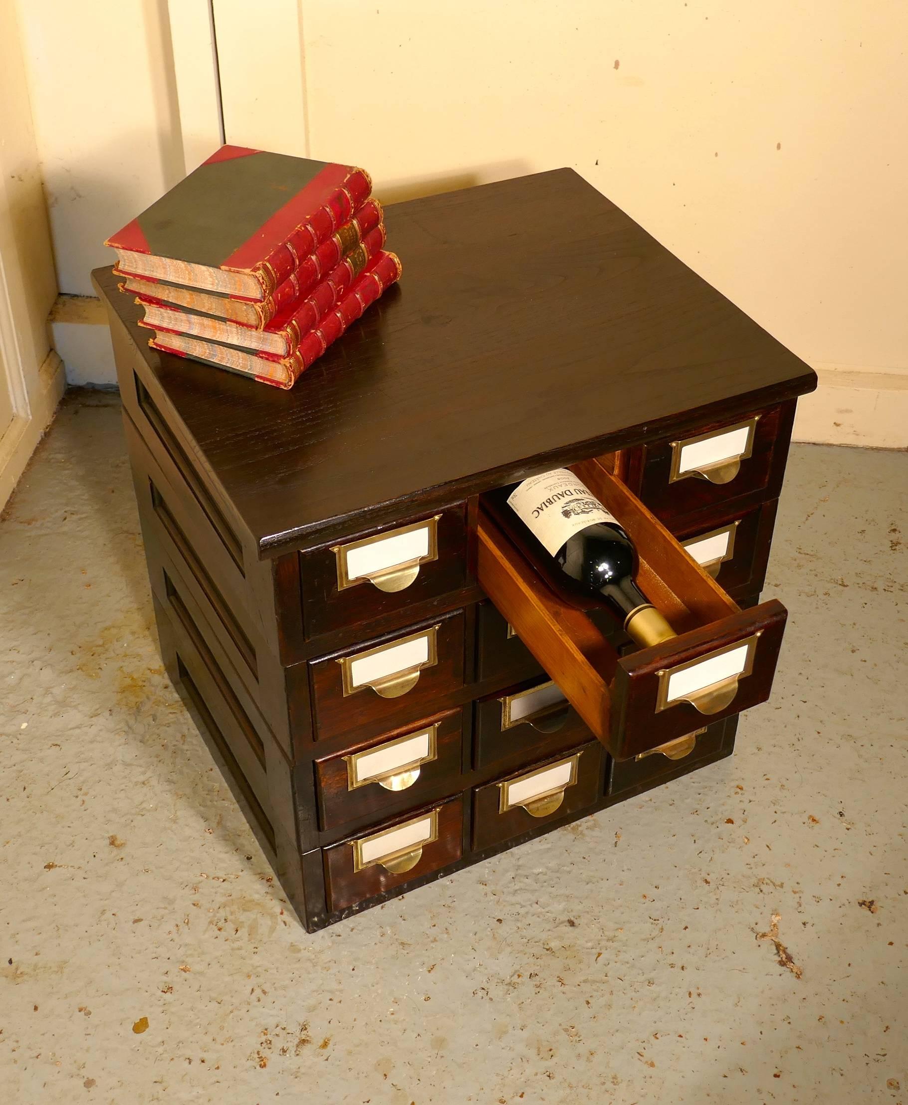 12 Drawer Oak Card Index Filing Cabinet, Wine Rack
 
The Cabinet has 4 rows of 3 drawers, each with a brass handle / name plate holder

The cabinet is in sound original condition all the drawers work smoothly  and the drawers are just the right size