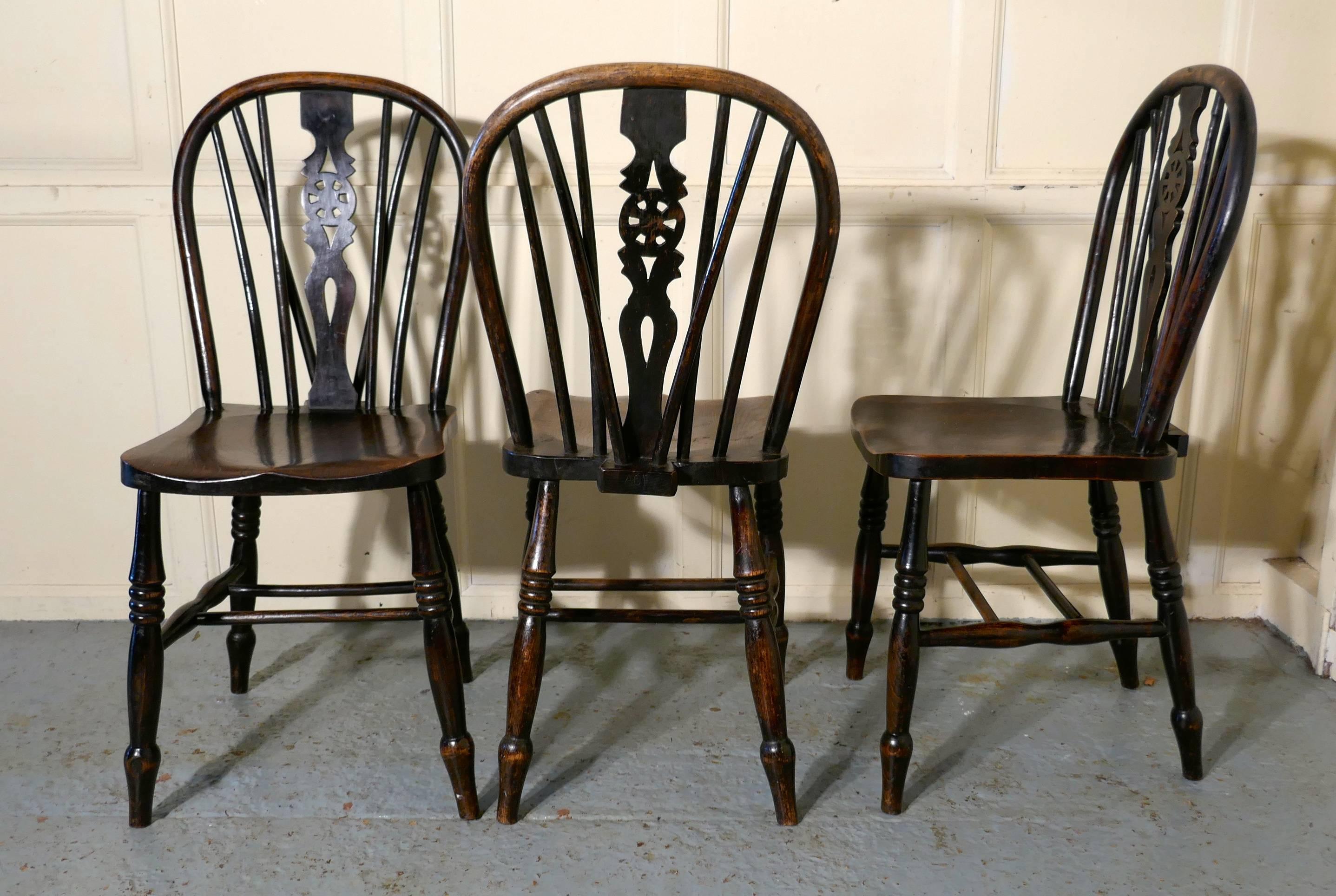 A set of six early Victorian beech and elm wheel back kitchen chairs

The chairs are a classic design, they have saddle shaped seats, a double stretcher underneath, hooped backs in the traditional Windsor style with a wheel design set in to the