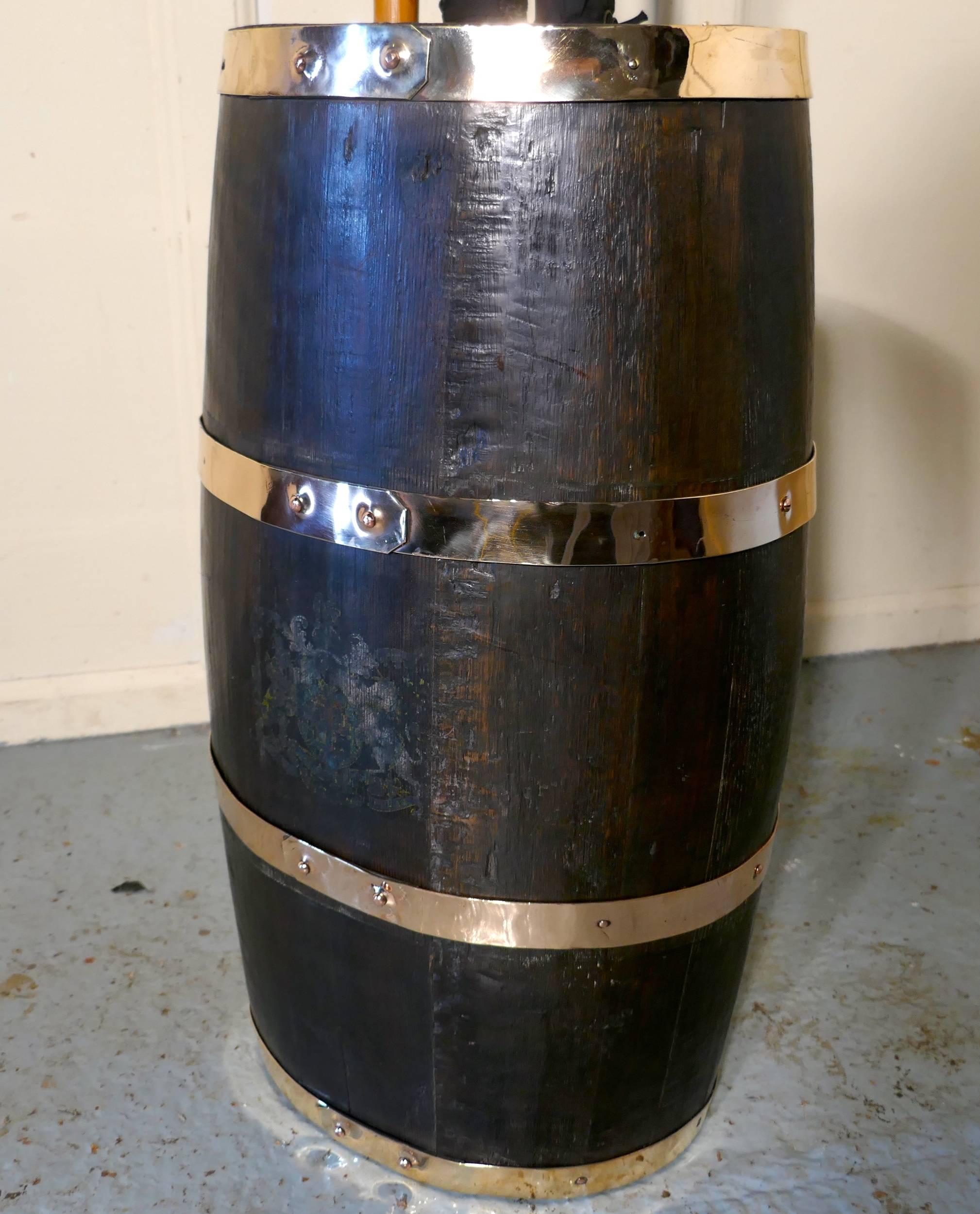 A large 18th century royal navy oak and brass bound powder barrel

This good looking piece originally used as a container for gun powder, it is oval in shape and made with oak staves and bound with four wide brass hoops
The royal coat of arms is