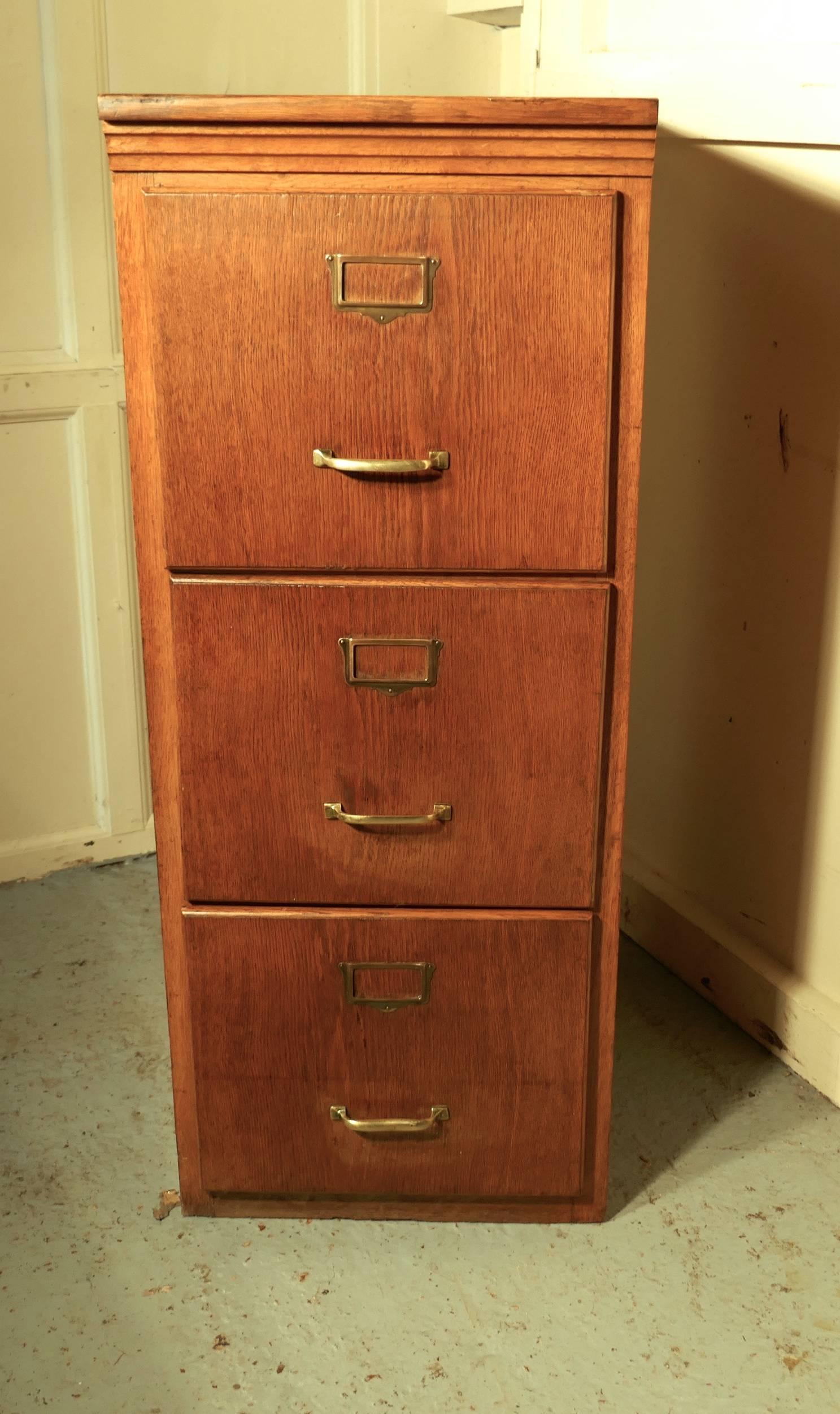 Large Edwardian three-drawer oak filing cabinet

This is an absolute must for every home office or study, the cabinet has three deep and roomy drawers, they all glide smoothly and have brass handles and card holders on the front, they will