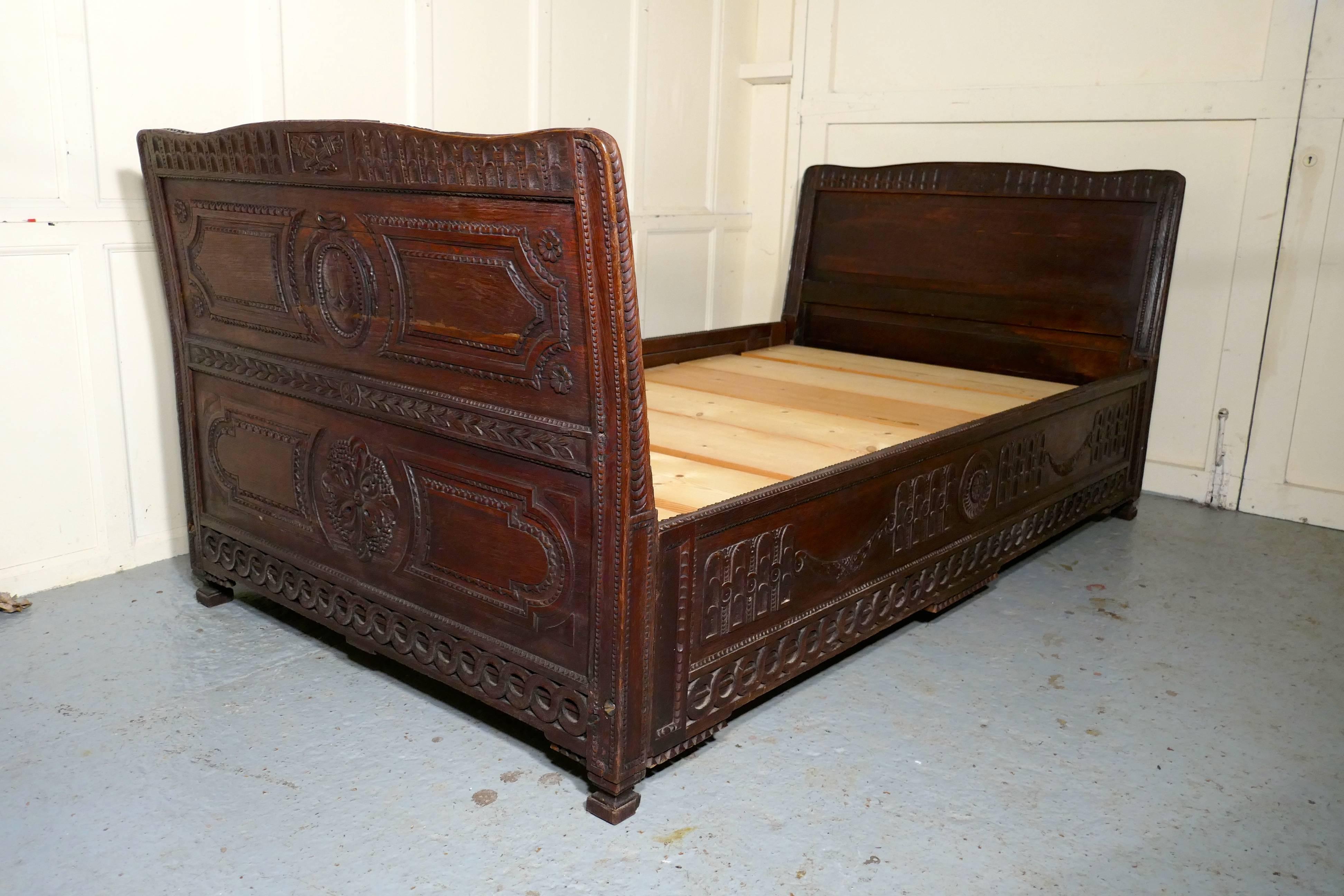 19th century carved oak day bed or ships sleigh bed.
 
This very unusual bed is very much in a nautical theme so it may have been taken from a ship.
The bed is made in oak and carved, both ends of the bed have an outward sweeping shape, making it