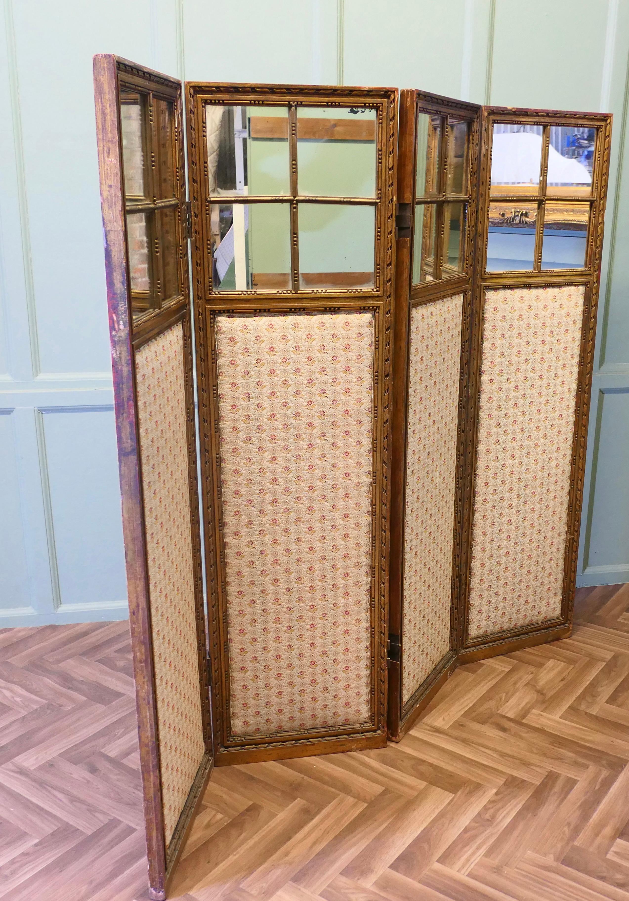 French Upholstered 4 Fold Screen, Gilt Mirror Room Divider 

Each of the 4 folds has a quilted upholstered panel with a quartered mirror above on one side and on the other there is a 19th Century print behind glass.

The screen is a substantial