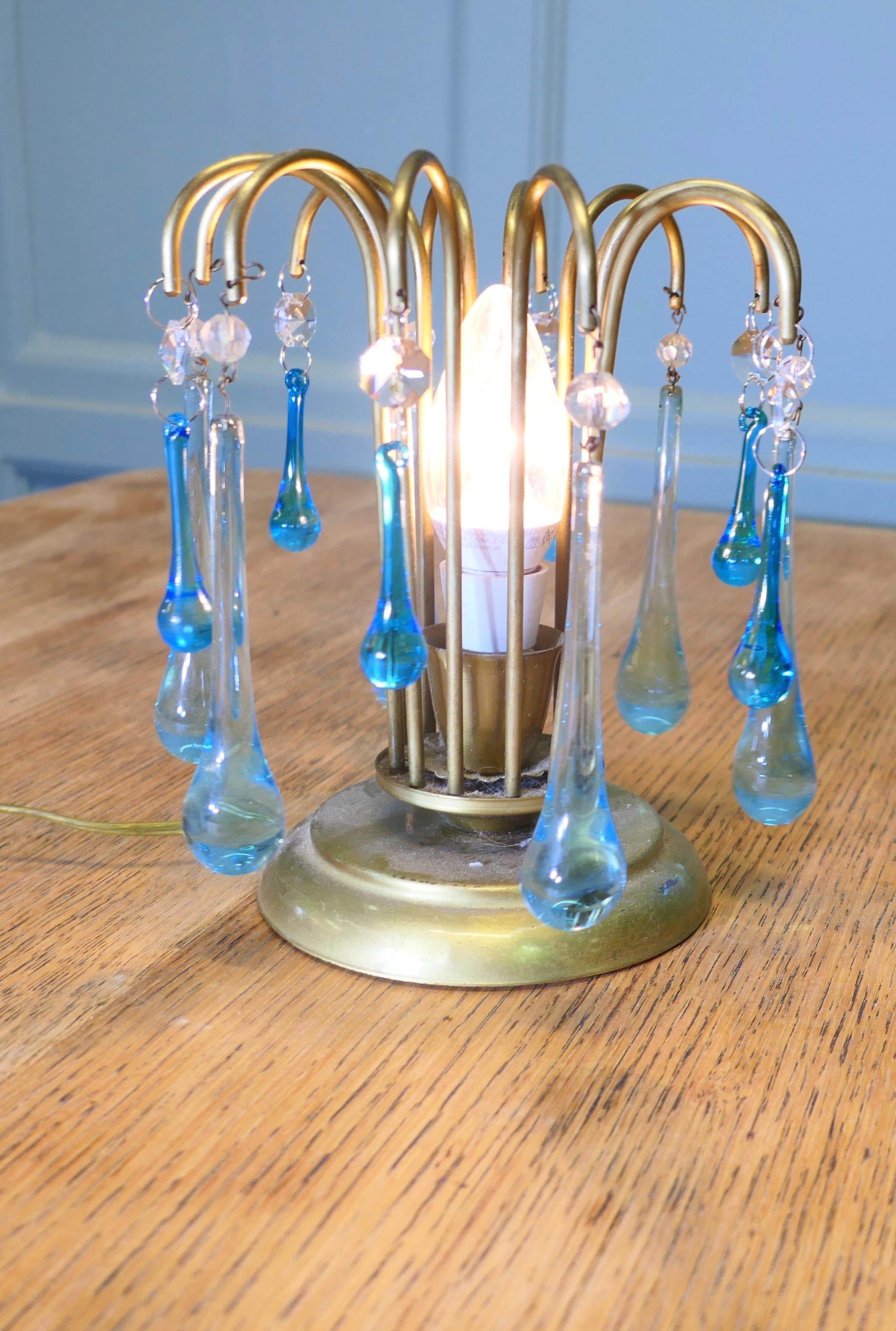 Turquoise Tear Drop Lustre Bed Side Lamp

A charming atmospheric little piece, this small brass lamp is hung with long Peacock Blue Teardrops and crystal beads, a very pretty piece
The lamp is 7” tall and 6” in diameter 
HW113